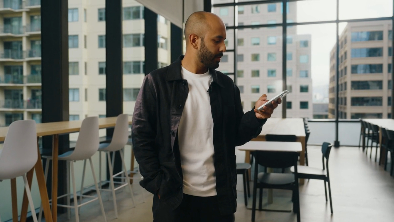 Man holding phone in an office