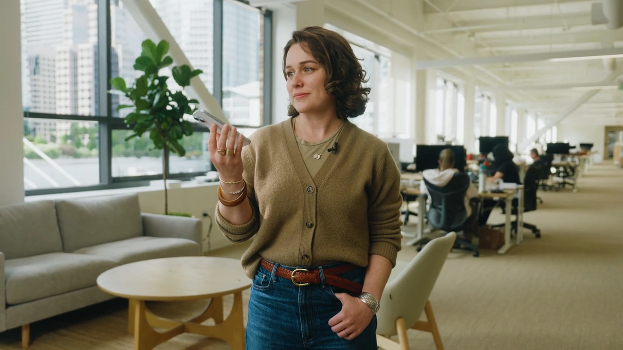 Woman holding phone in an office