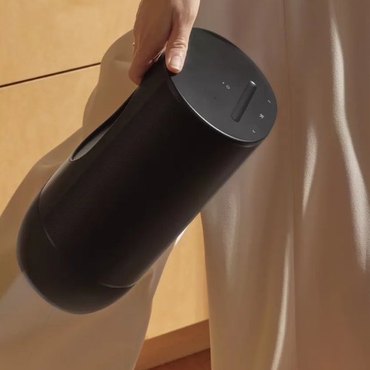 Woman walking with Sonos speaker