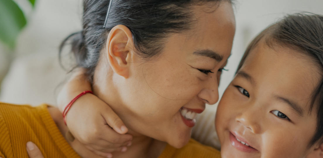 A happy mother and child hugging.