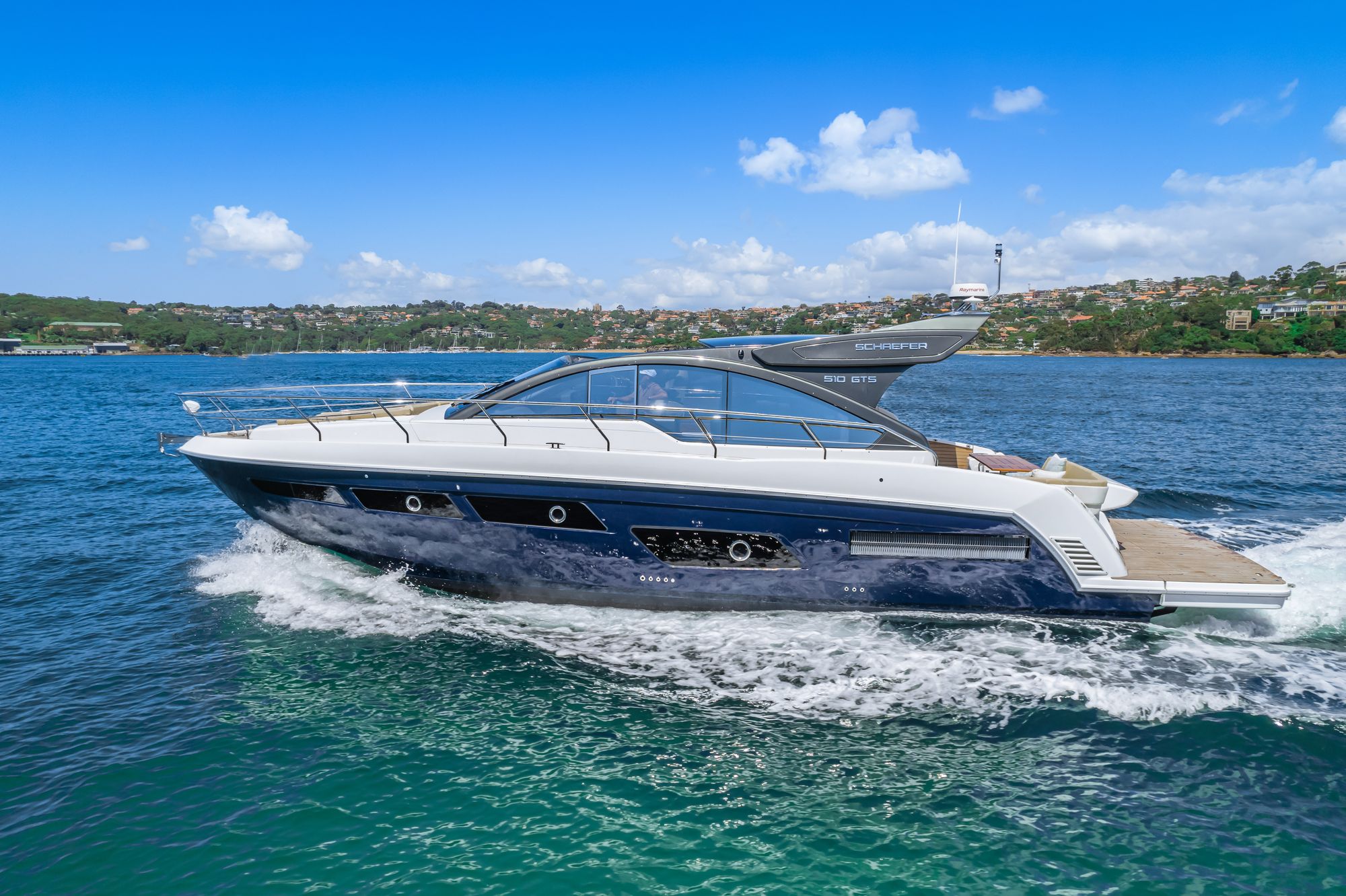 Schaefer 510 GTS at speed with the harbour foreshore behind