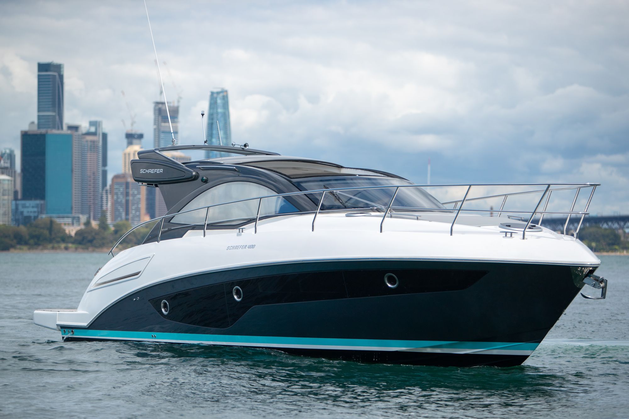 Schaefer 510 GTS on Sydney Harbour with the city skyline behind