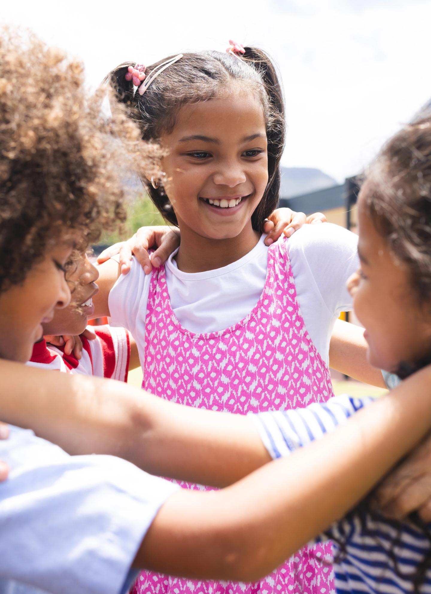 Children embracing outdoors