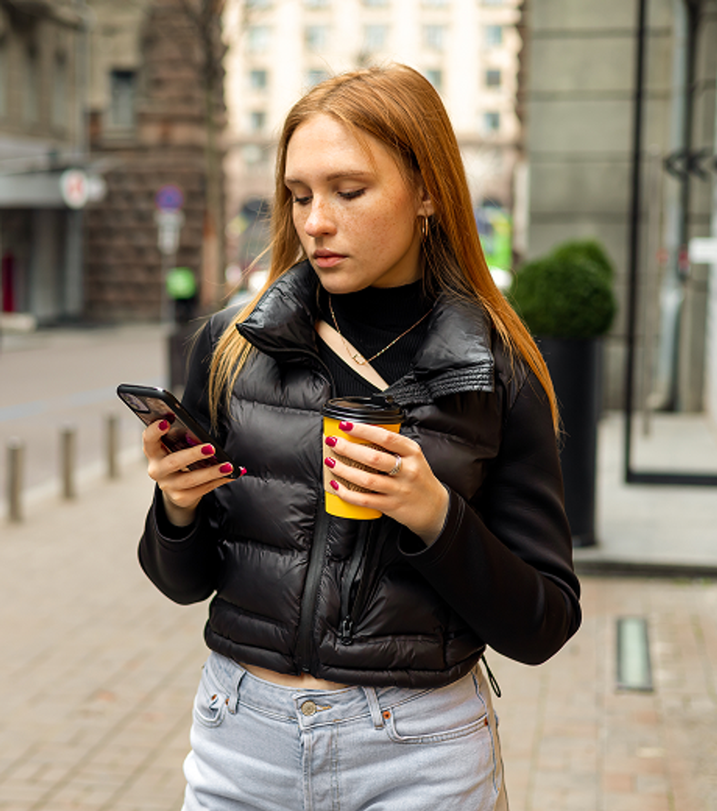 Survivor walking outdoors with phone