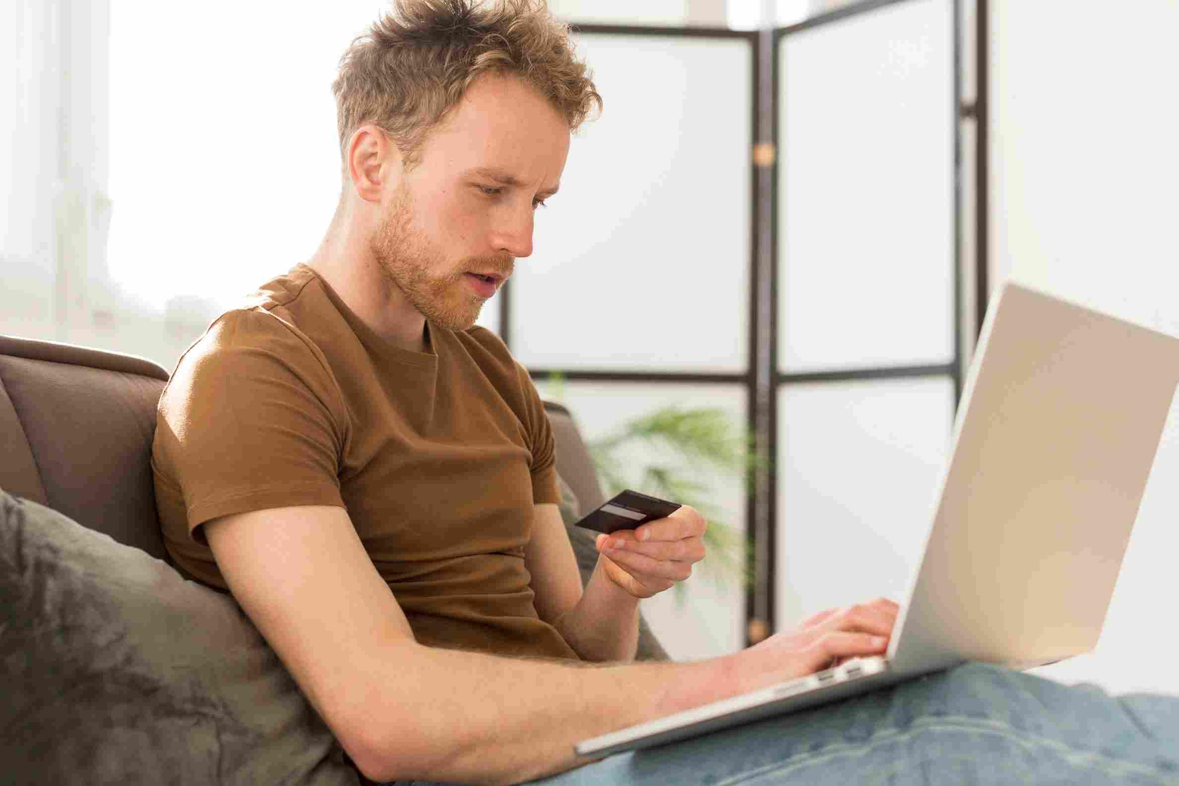 Man using credit card online, exploring chargebacks and merchant tips for protection.