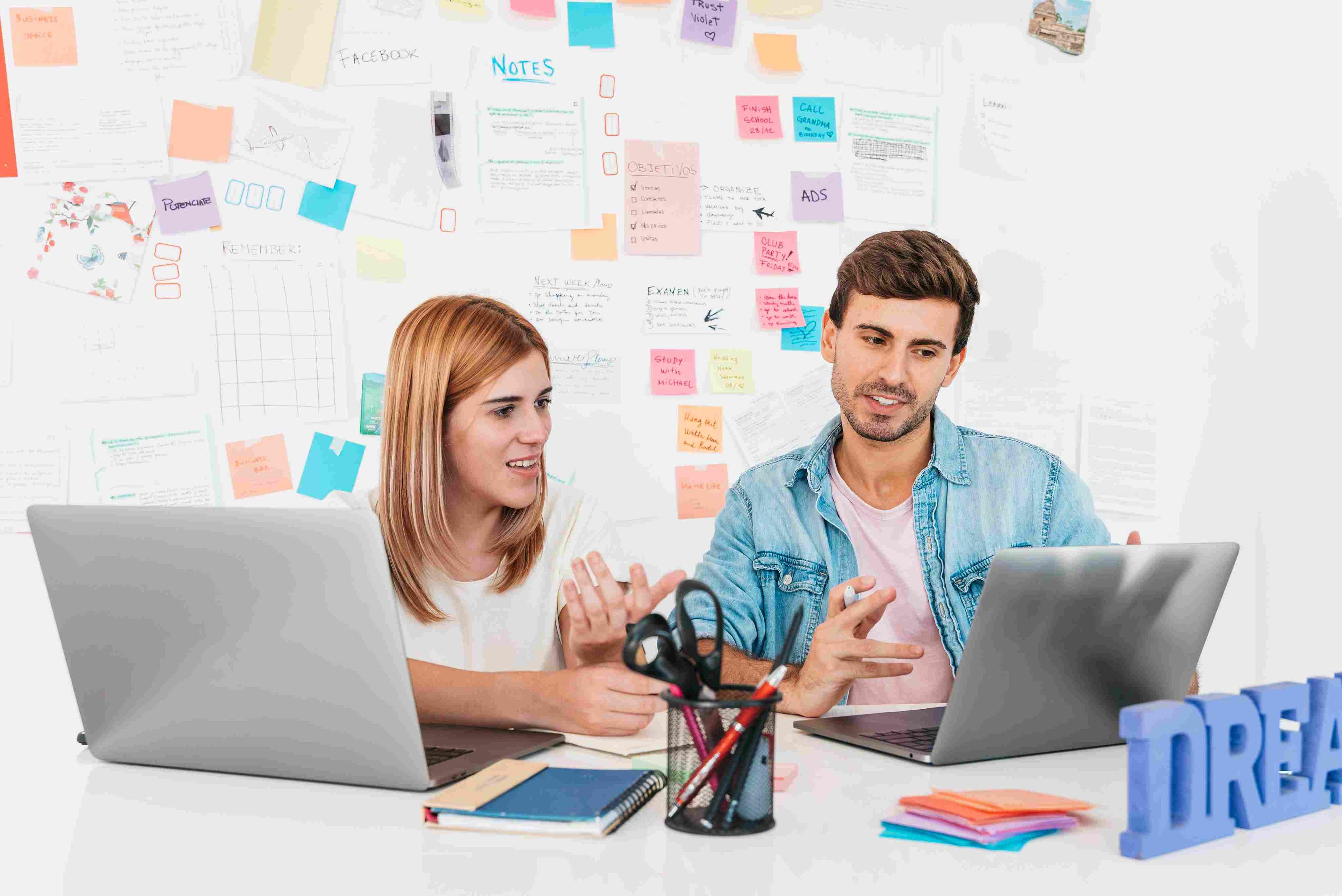 Two professionals discussing secret marketing tools at a creative workspace.