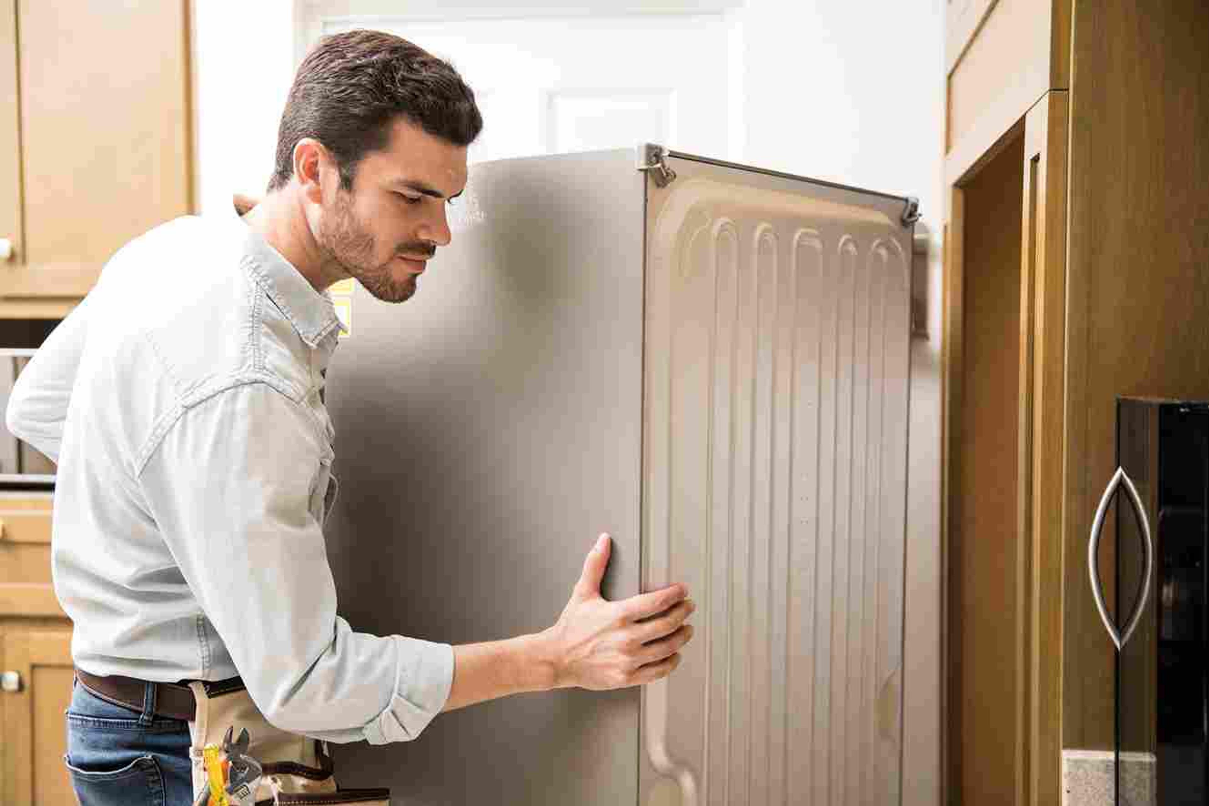 Man dealing with malfunctioning refridgeraor