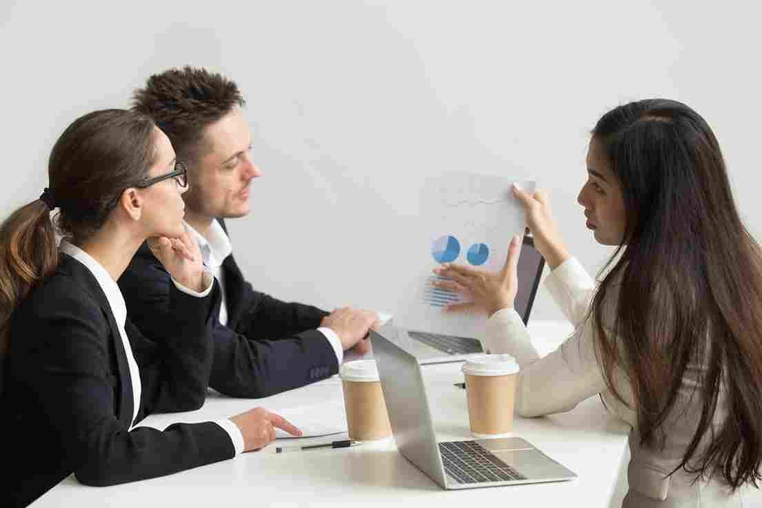 Business team discussing conversion rate optimization strategies for 2025 in meeting room.