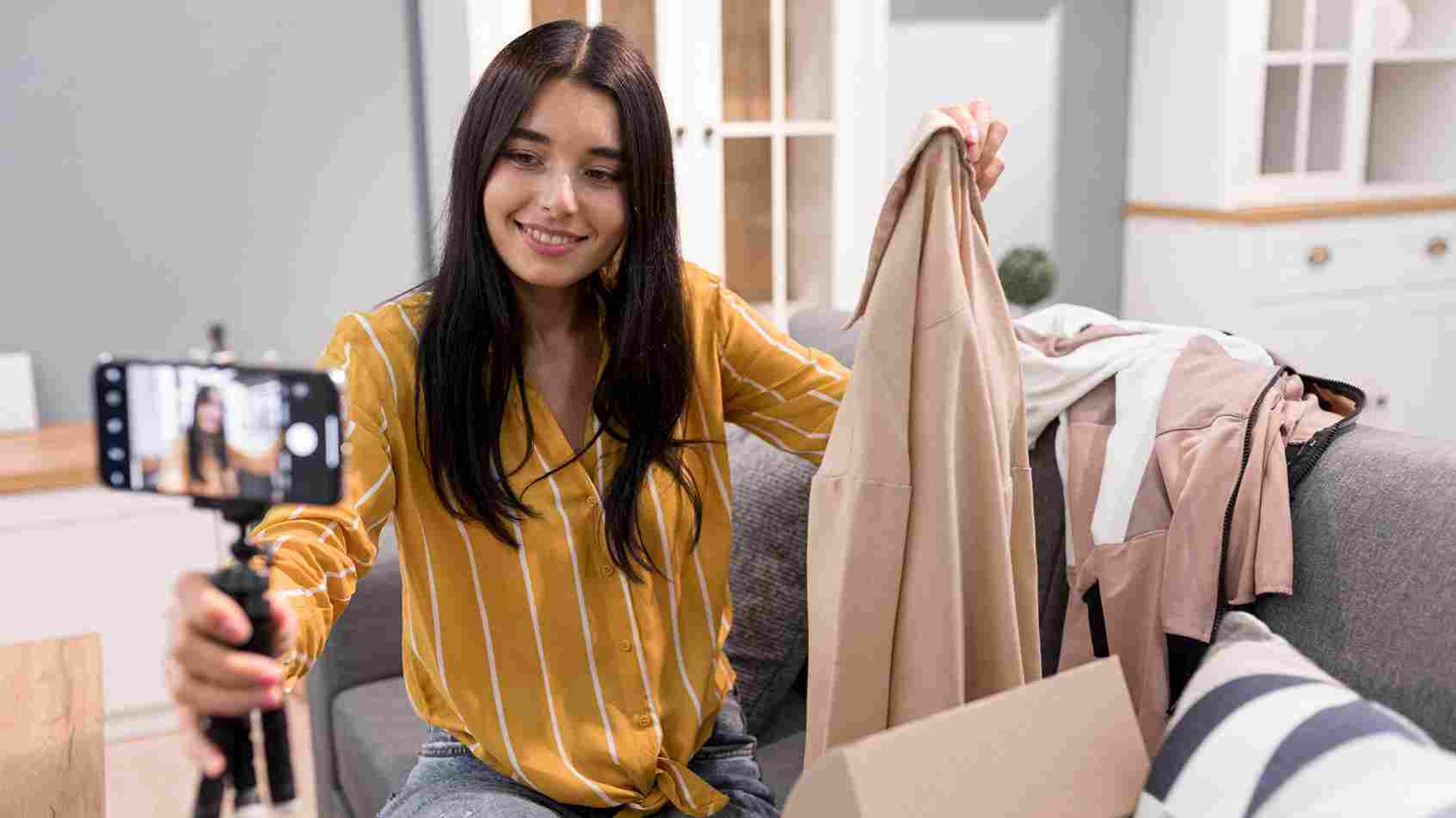 Presenter showcasing fashion items during a live commerce session for merchants.