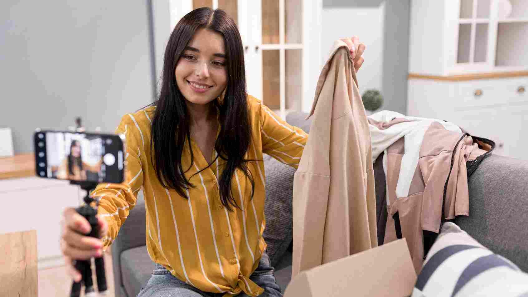 Presenter showcasing fashion items during a live commerce session for merchants.