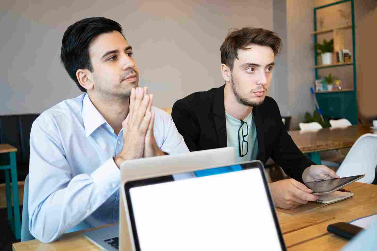 Business professionals discussing marketing strategies for Reddit in a modern workspace.