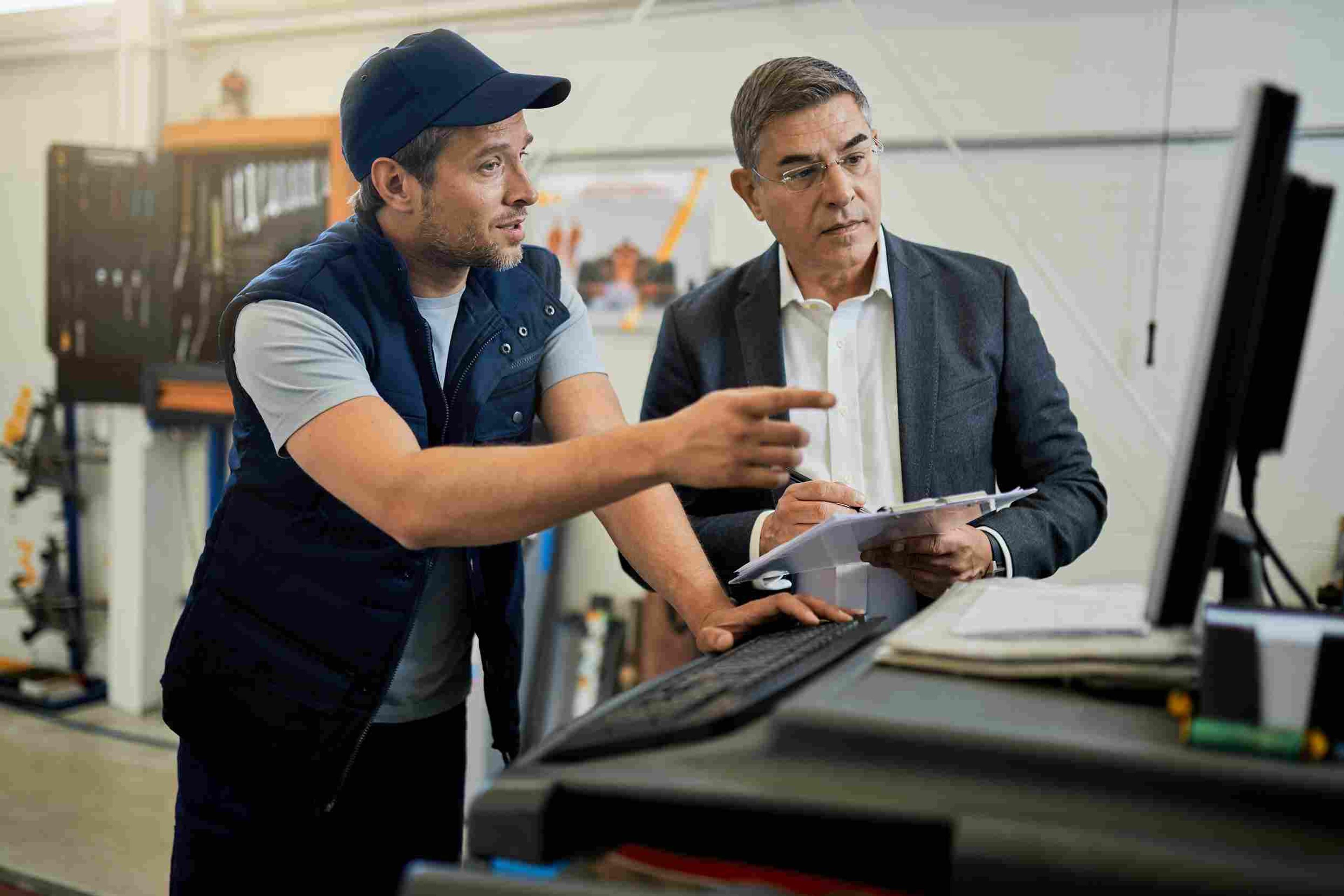 Customer discussing product protection options with a salesperson at a retail store.