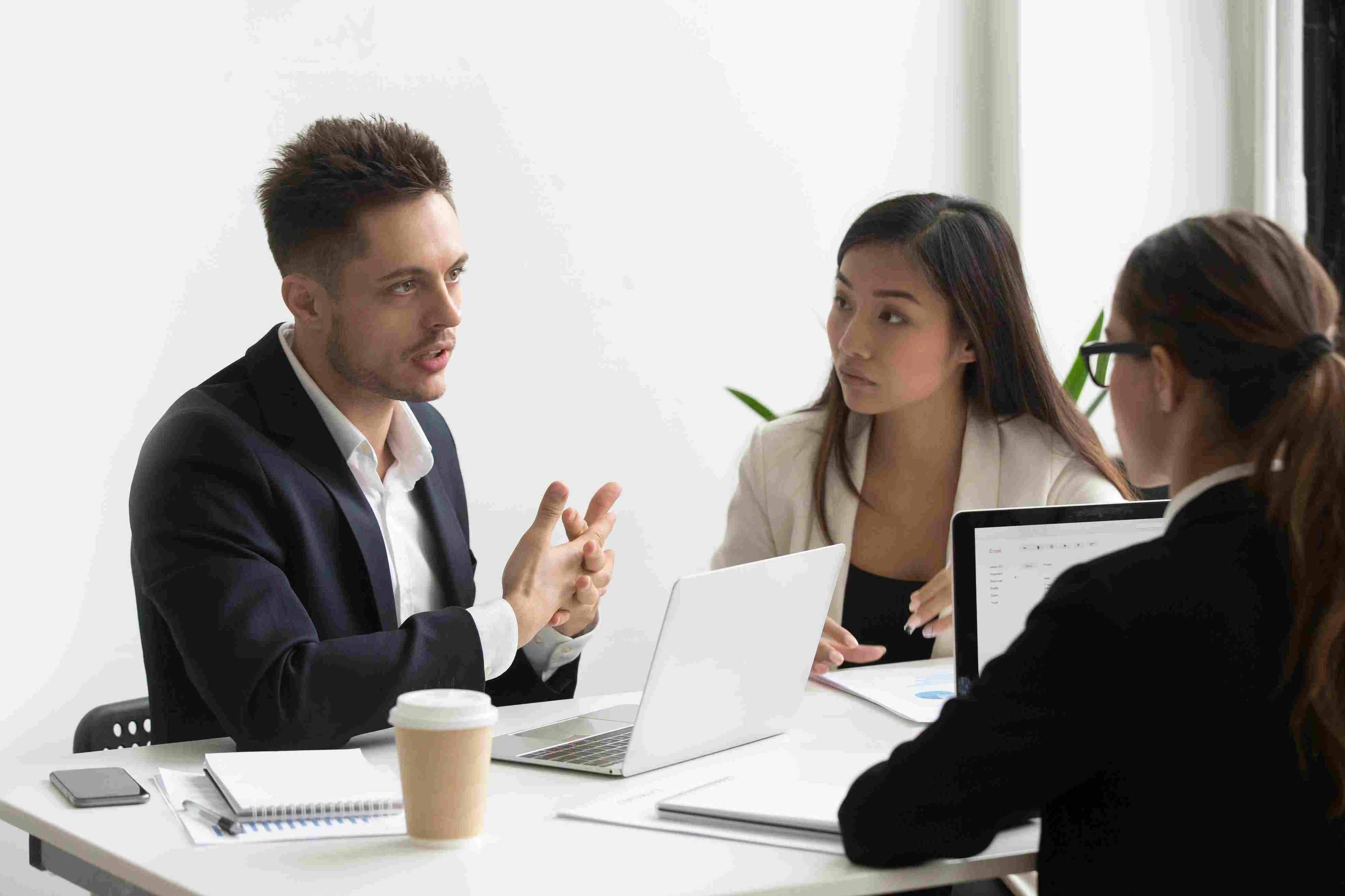 Business meeting discussing strategies to combat chargebacks and share success stories.