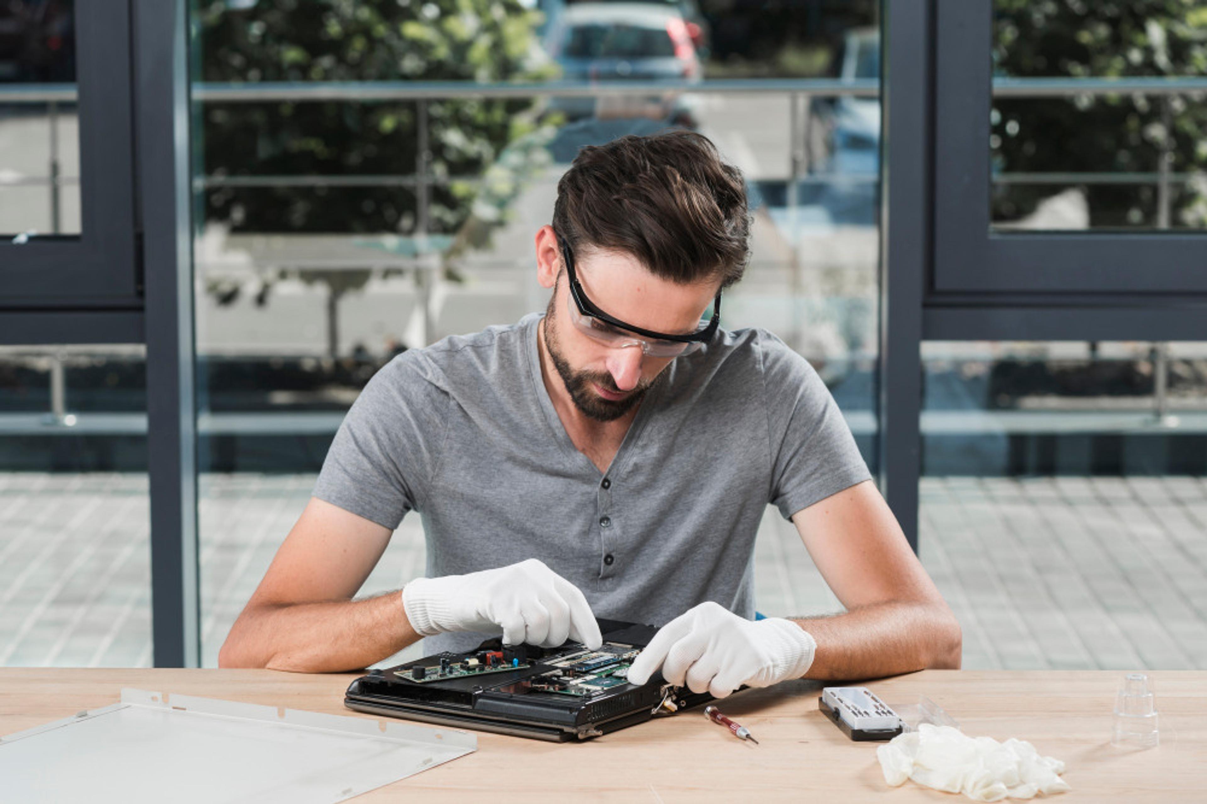 Technician exploring eco-friendly warranty solutions for electronic waste management.