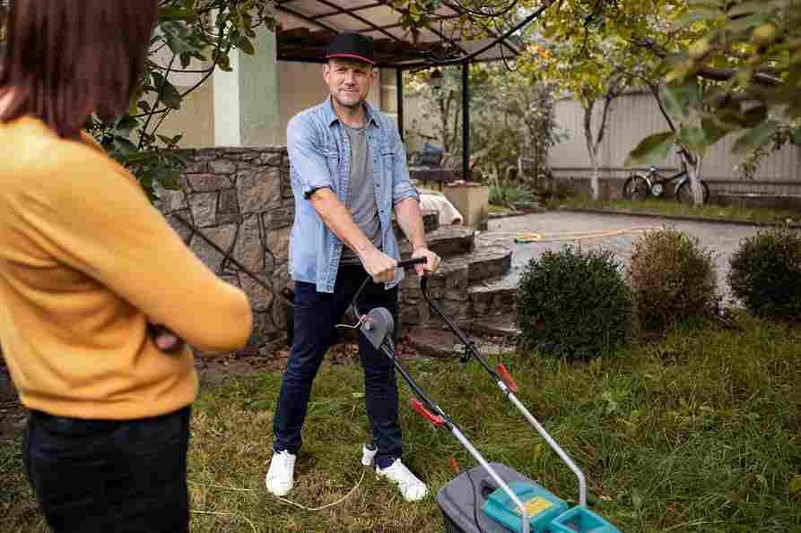 Man mowing lawn, exploring lawnmower warranties and repair options for reliability.