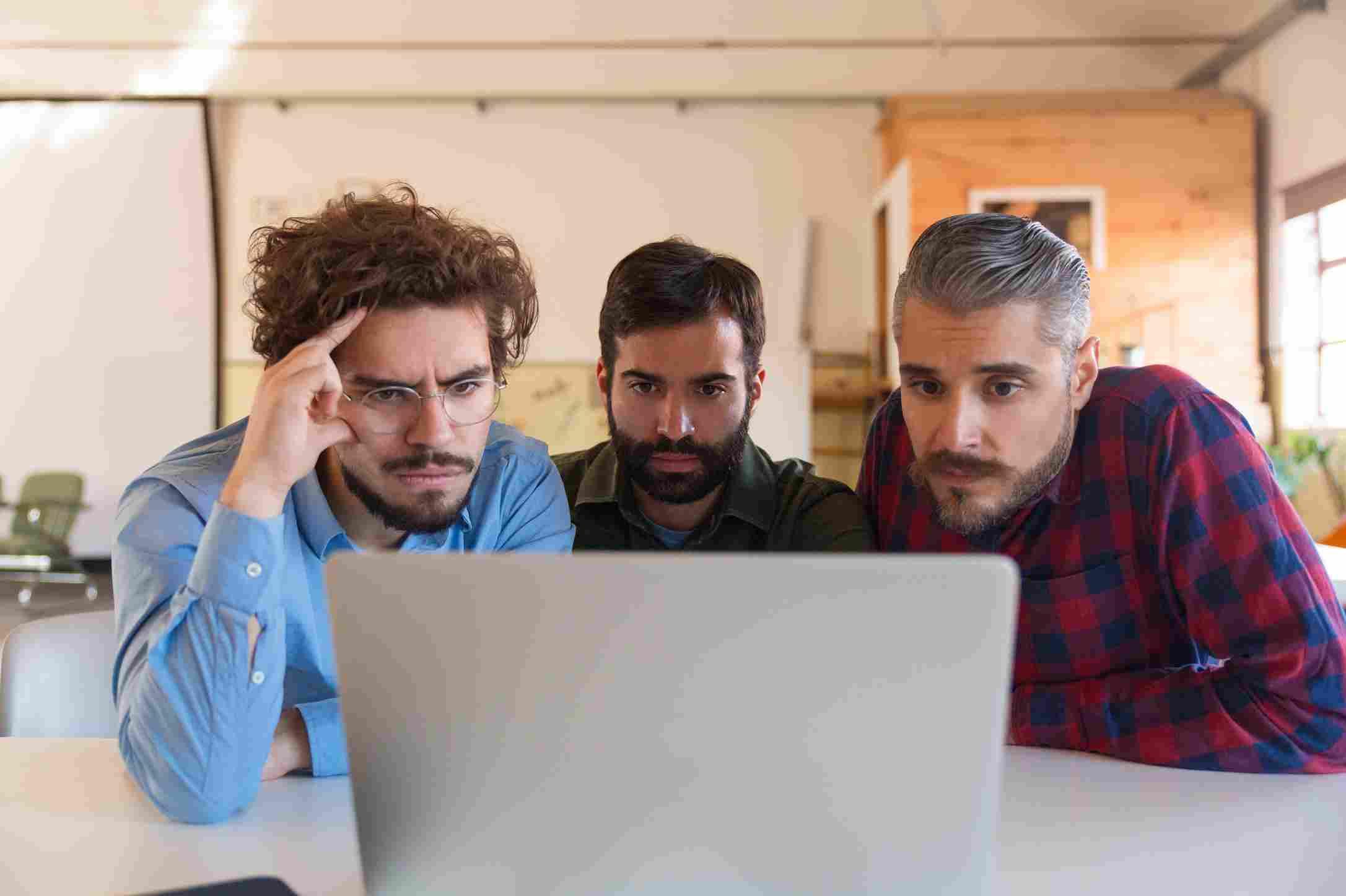 Three professionals analyzing Walmart's instant checkout strategy for e-commerce merchants.