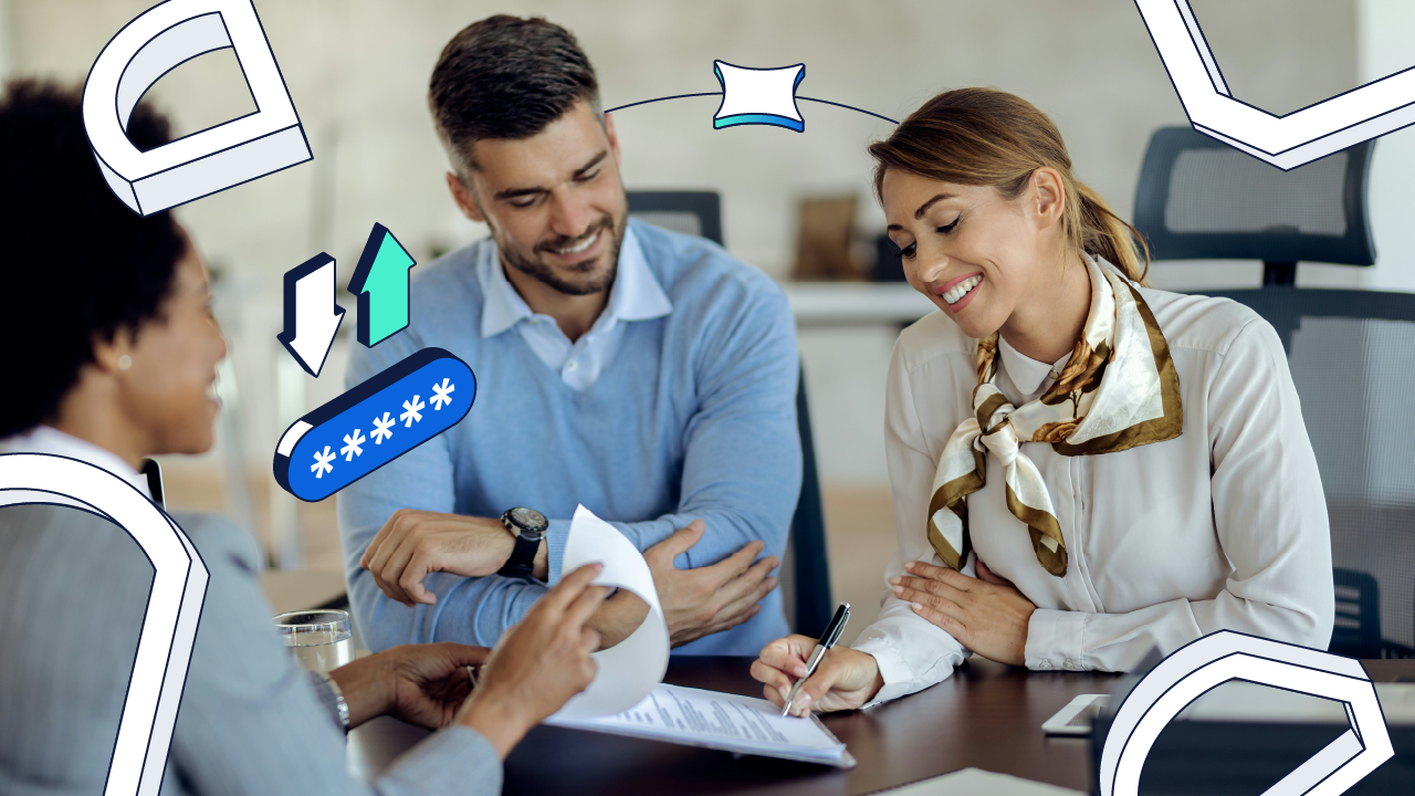 Three smiling individuals ware around a table while one signs a document