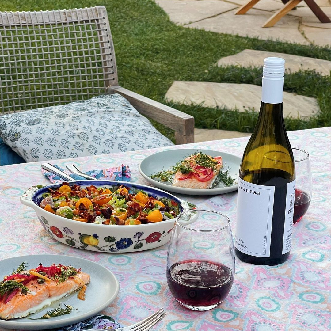 Dinner table with red wine and salads