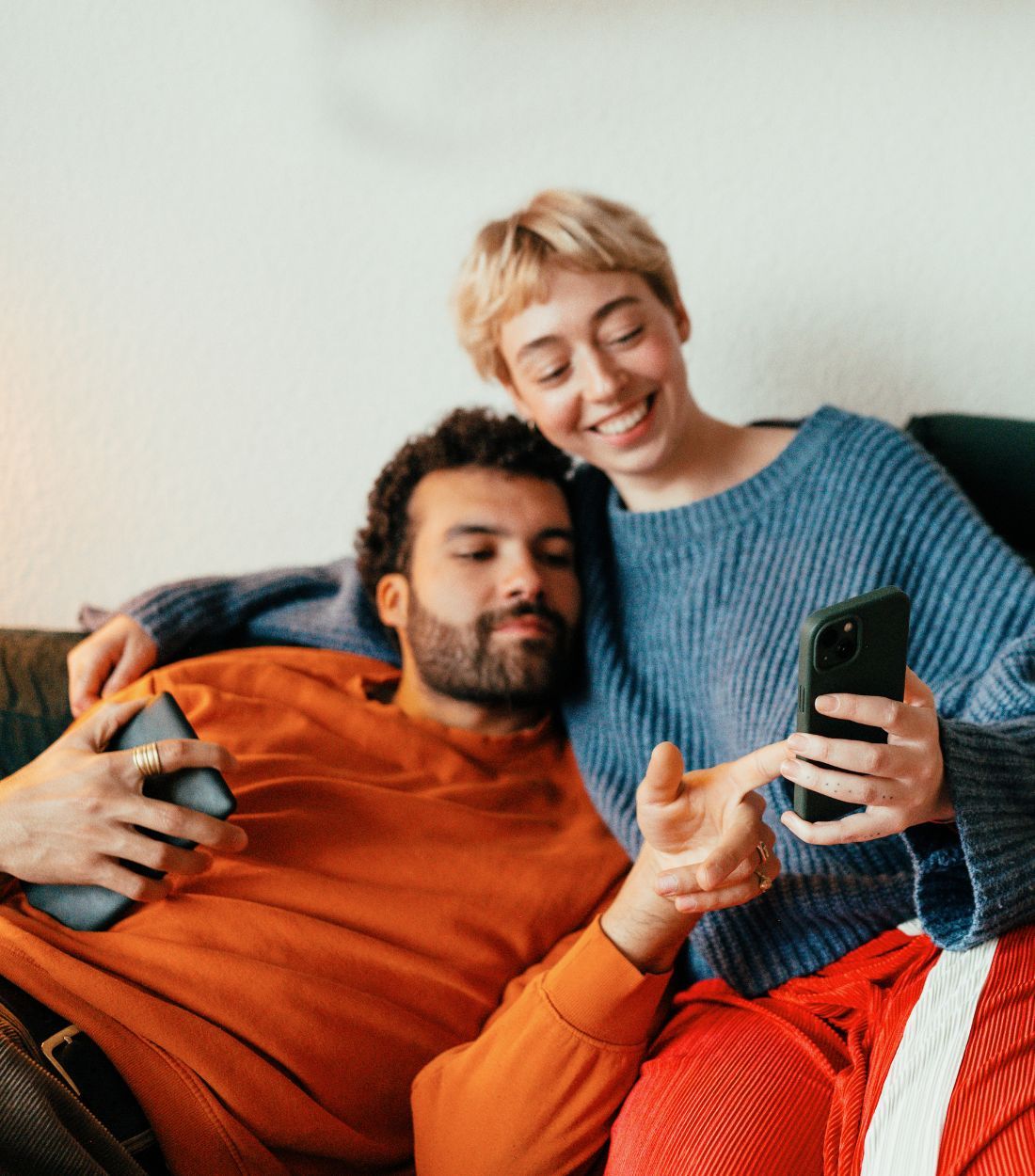 Couple at home looking at phone