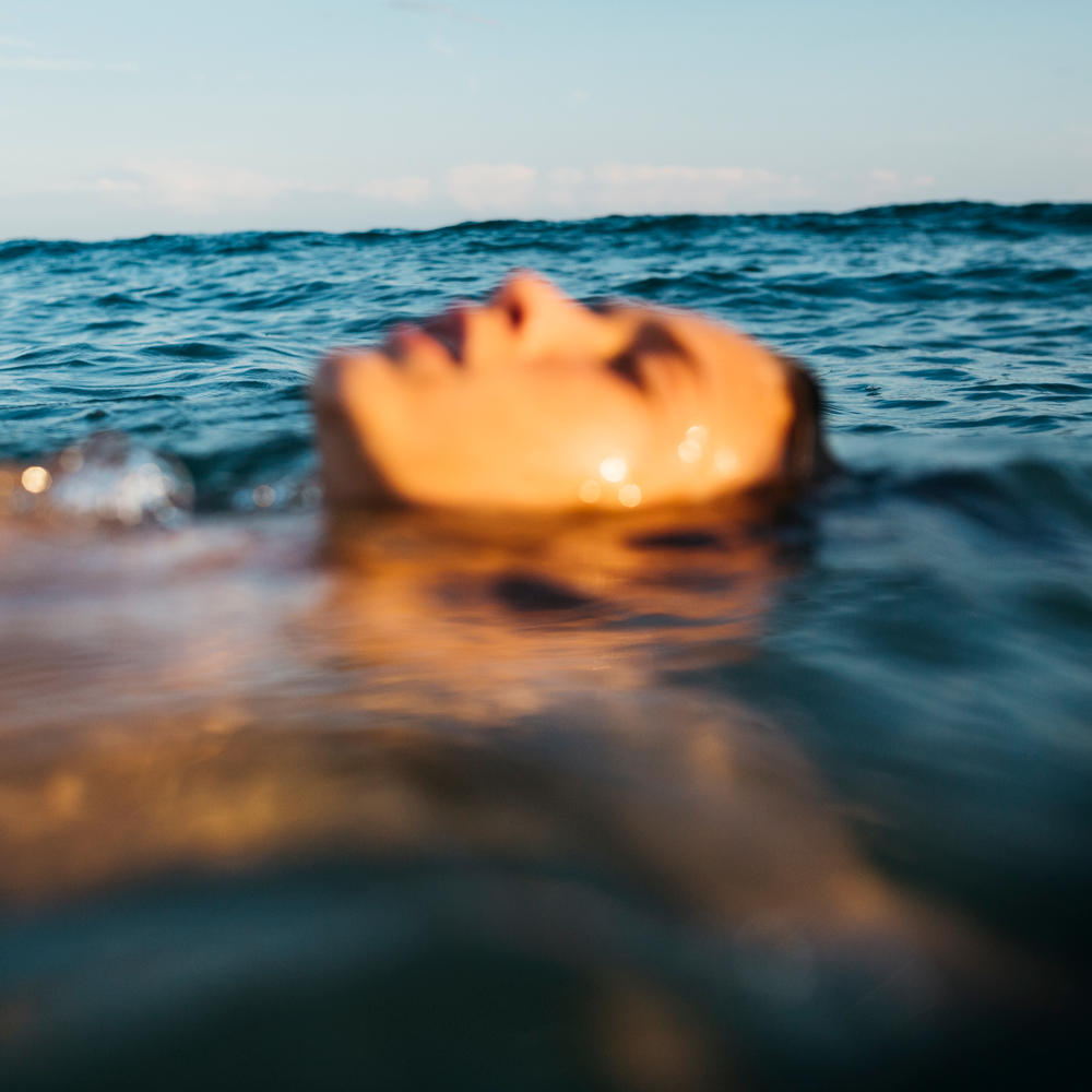 Woman floating in the ocean. 