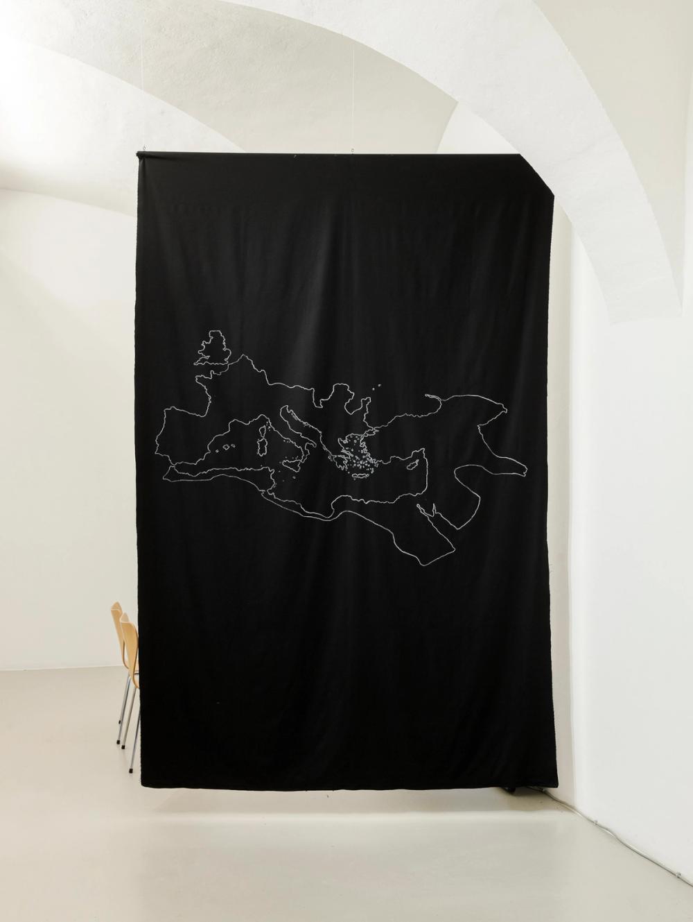 Samia Henni, 'Psychocolonial Spaces - Act 1', exhibition view, Ar/Ge Kunst. Disegno in gesso della mappa dell’Impero Romano nel 117 su tessuto di cotone nero.