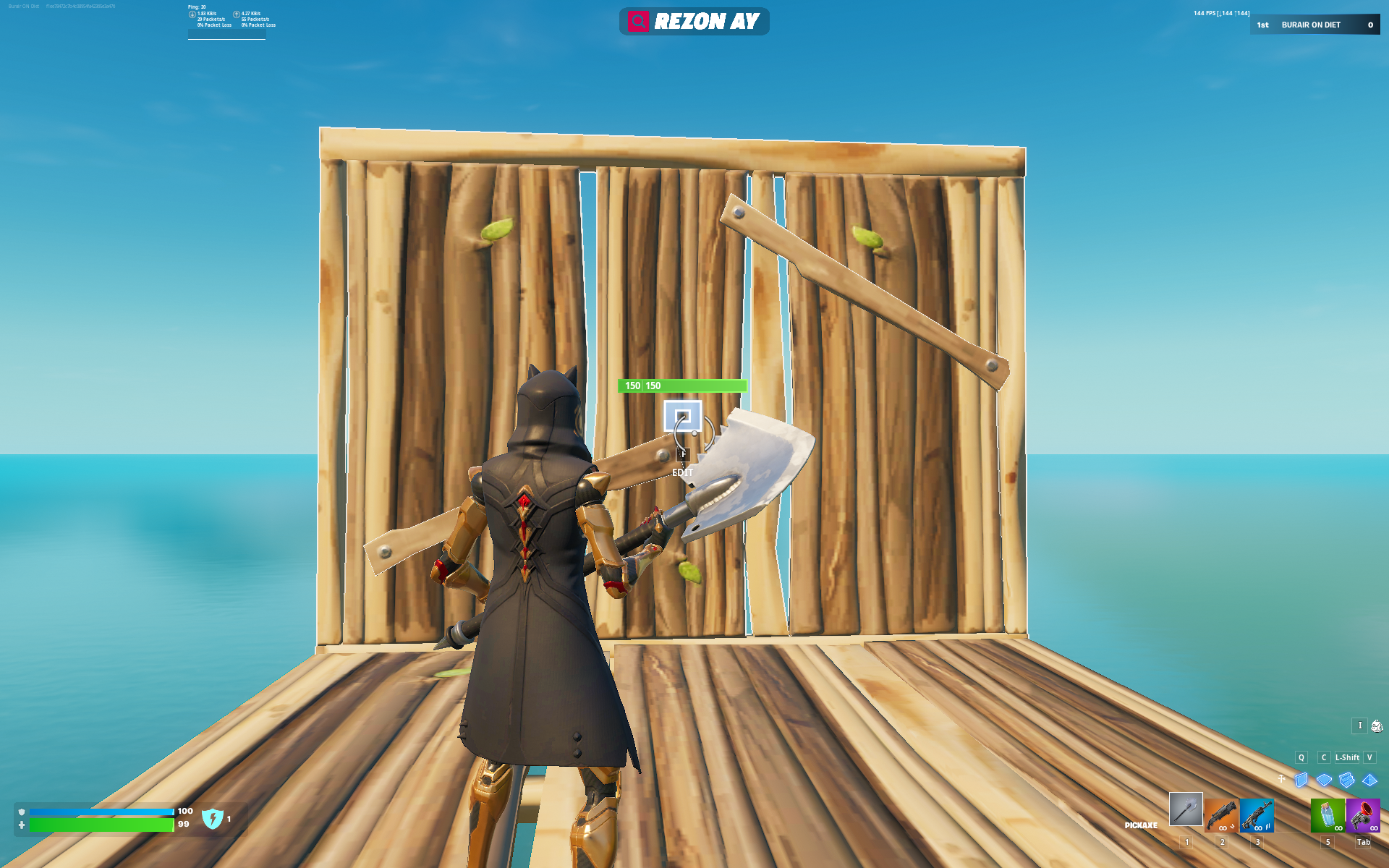 A man standing on a wooden floor with a single wood wall in front of him