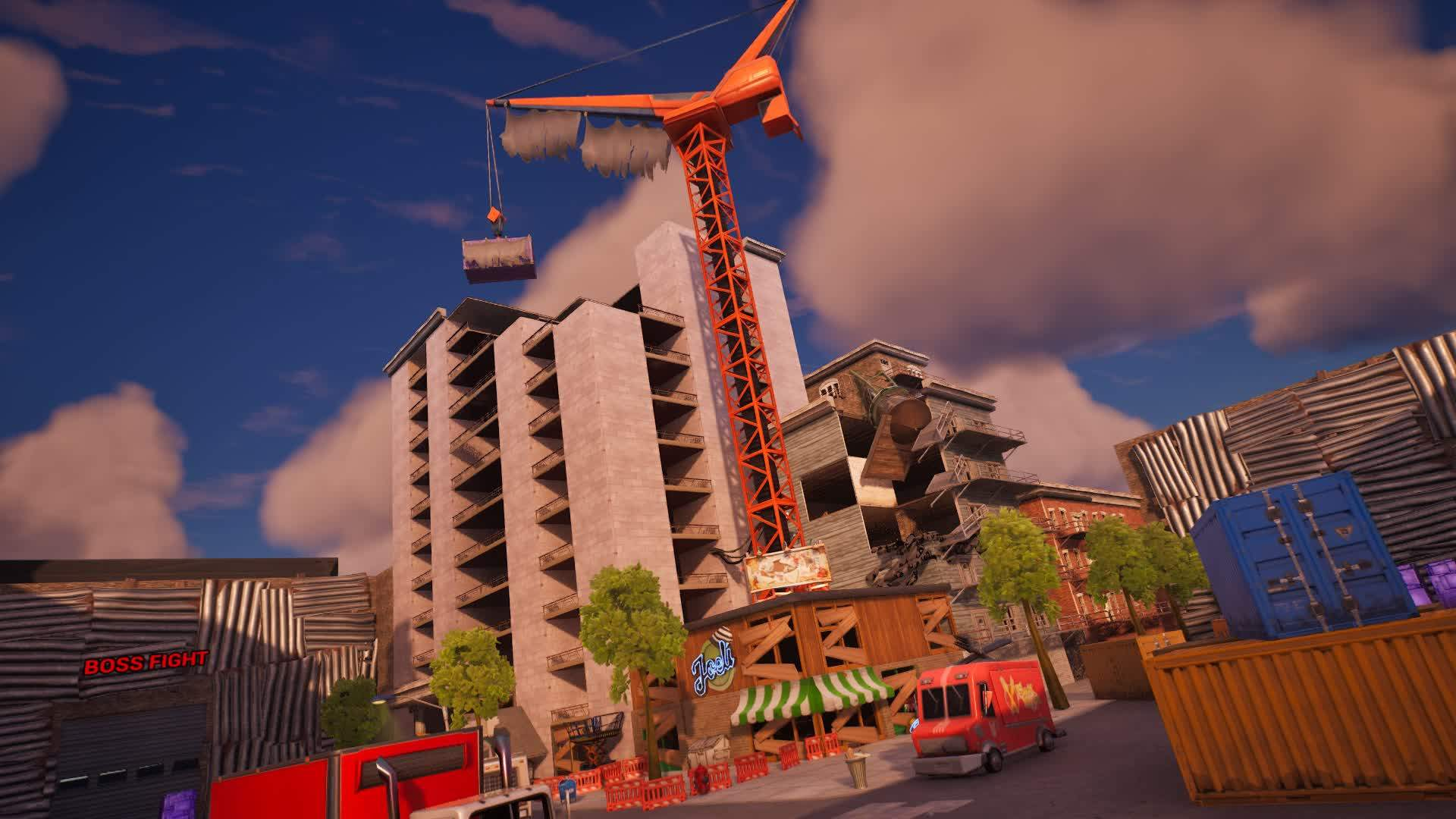 A tower with a construction crane over it.