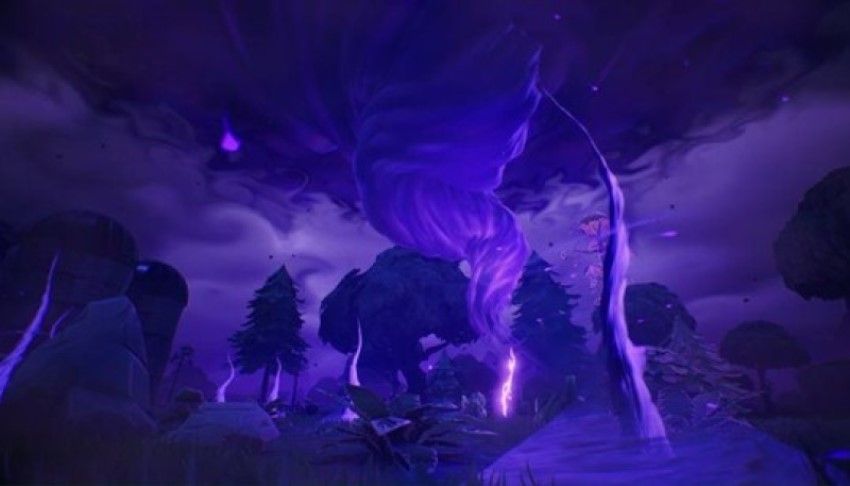 A purple cyclone over a forest
