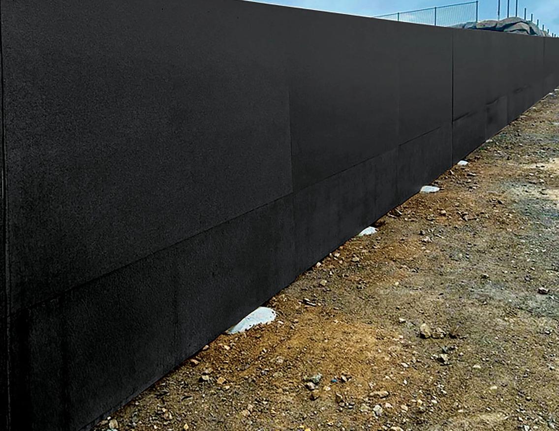 A closeup of STRUCTApanel® Black installed as hoarding about a new Impact Designer Homes site