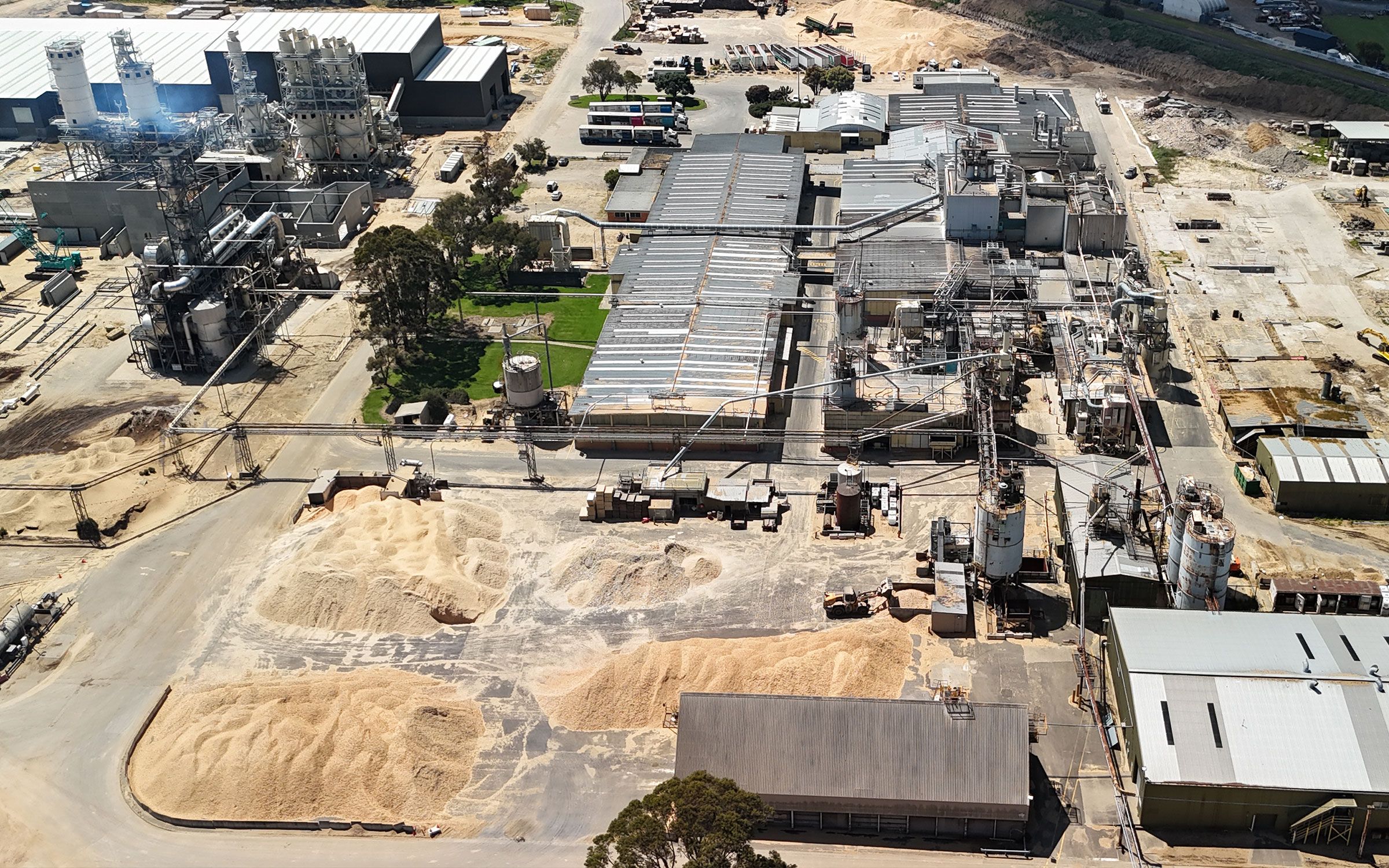 Packs of CUSTOMpine particleboard strapped on a rollers in a factory