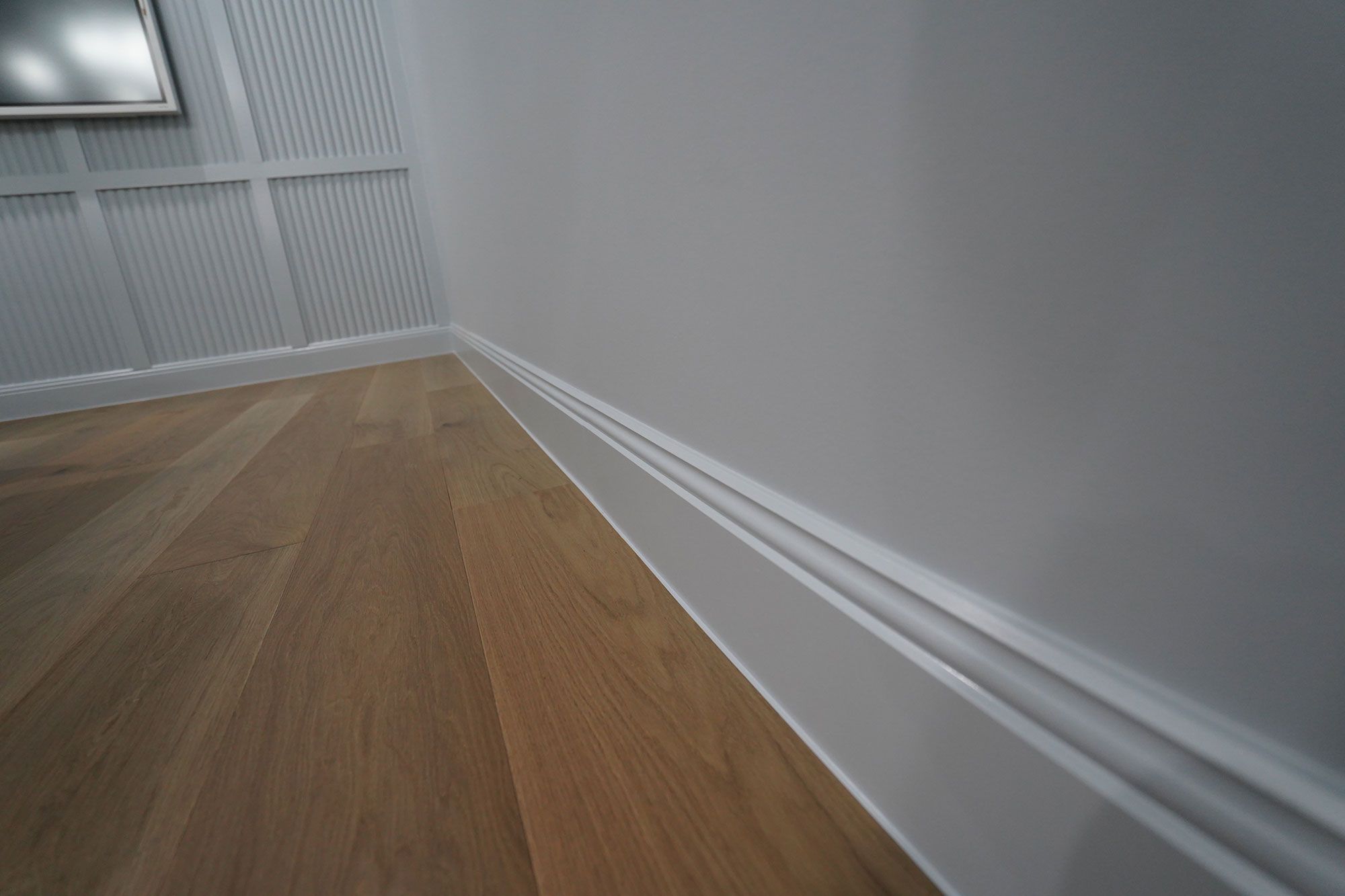 A close up of a skirting board and wall of porta timbers