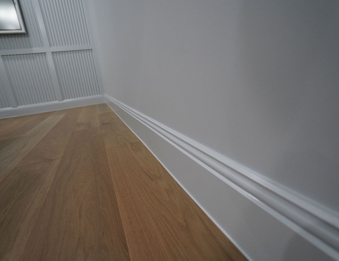 A close up of a skirting board and wall of porta timbers