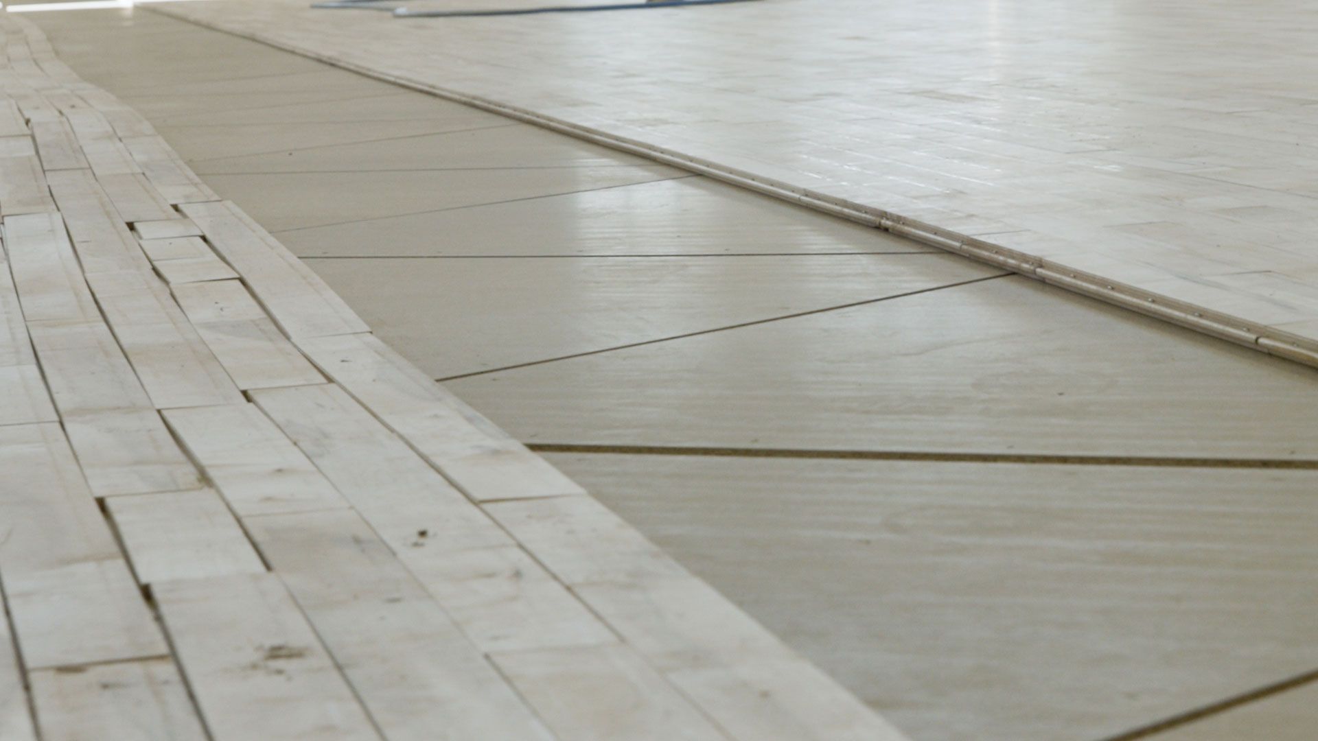 Closeup of STRUCTApanel® 12mm underneath a basketball stadium floor
