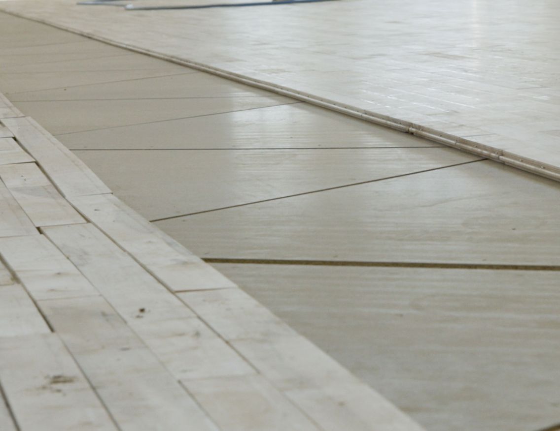 Closeup of STRUCTApanel® 12mm underneath a basketball stadium floor