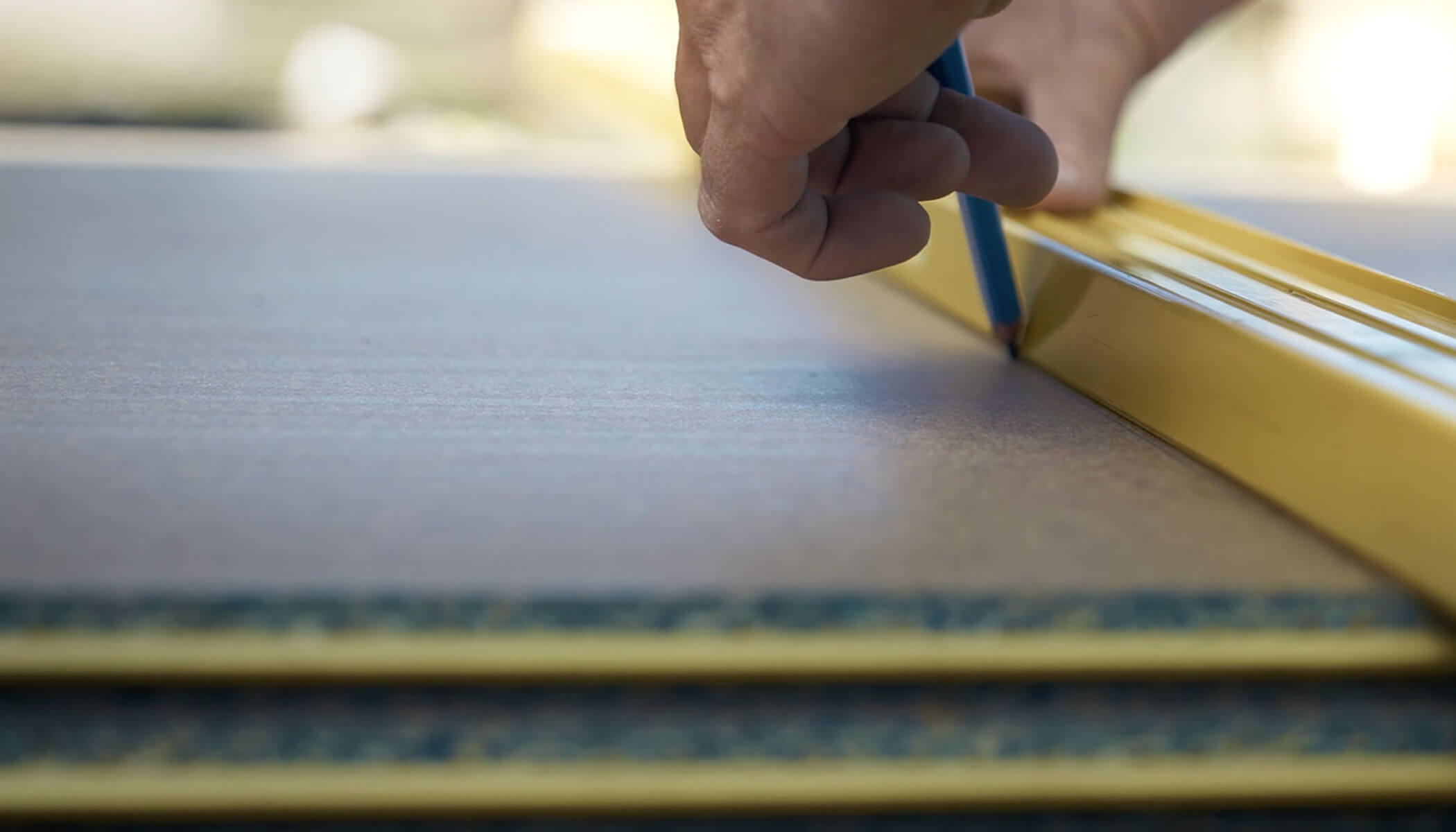 A tradie marking up STRUCTAflor termite treated boards with a level and pencil