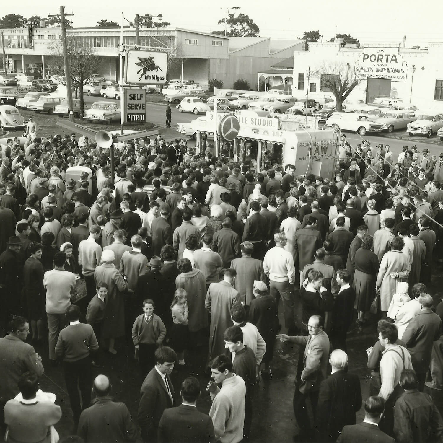 A historical black and white image of a crowd of porta staff outside of the original porta building