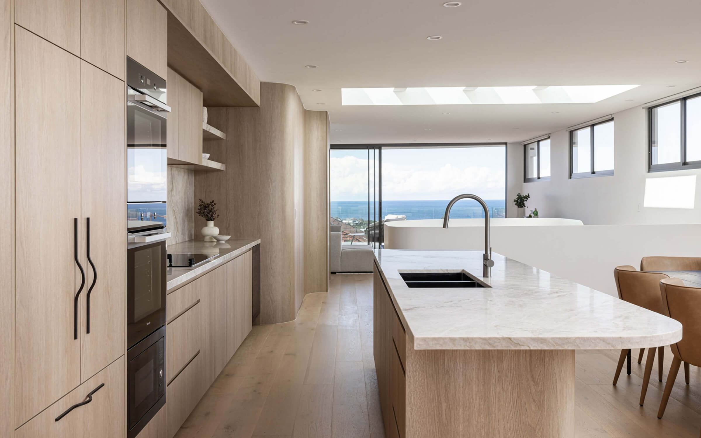 A beautiful Colourpyne kitchen in light oak timbers with an outlook of a beach