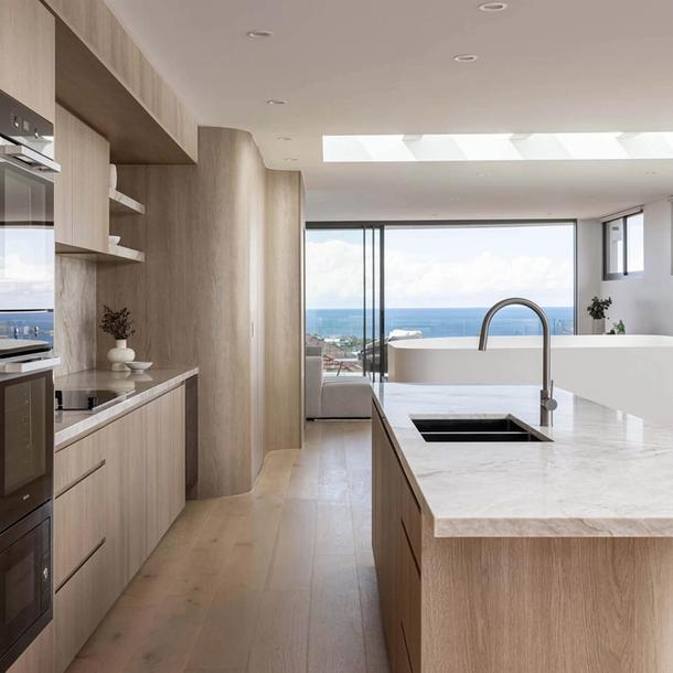 A beautiful Colourpyne kitchen in light oak timbers with an outlook of a beach