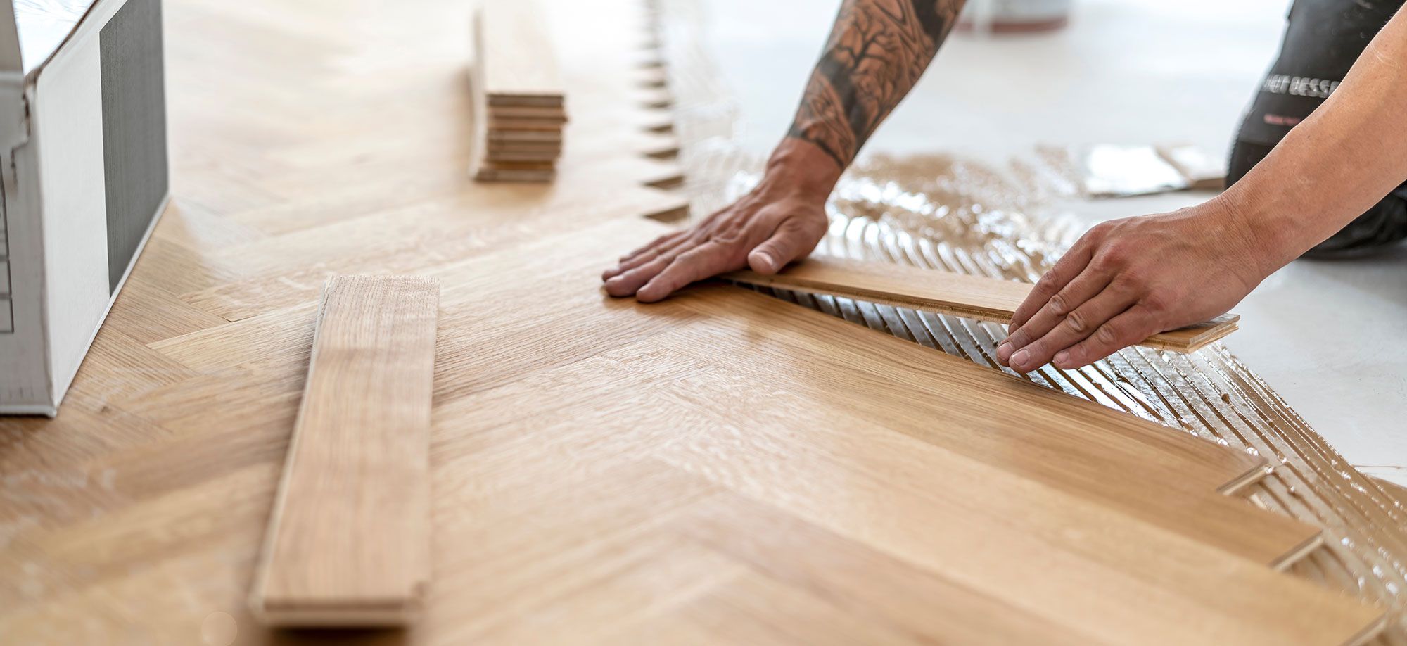 Carpenter installing parquetry floor