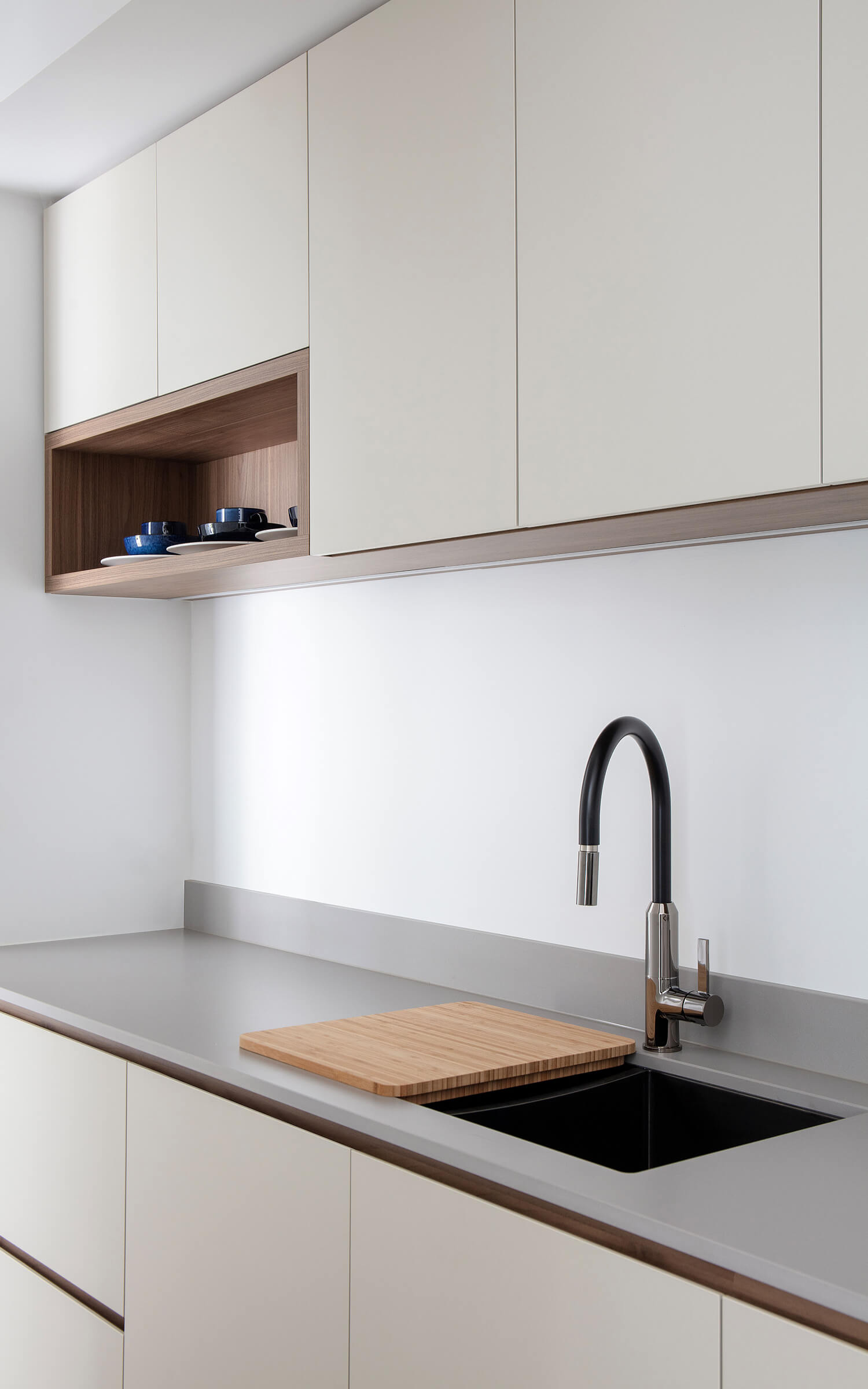 A cropped in image of a Colourpyne kitchen showing kitchen cupboards and a benchtop