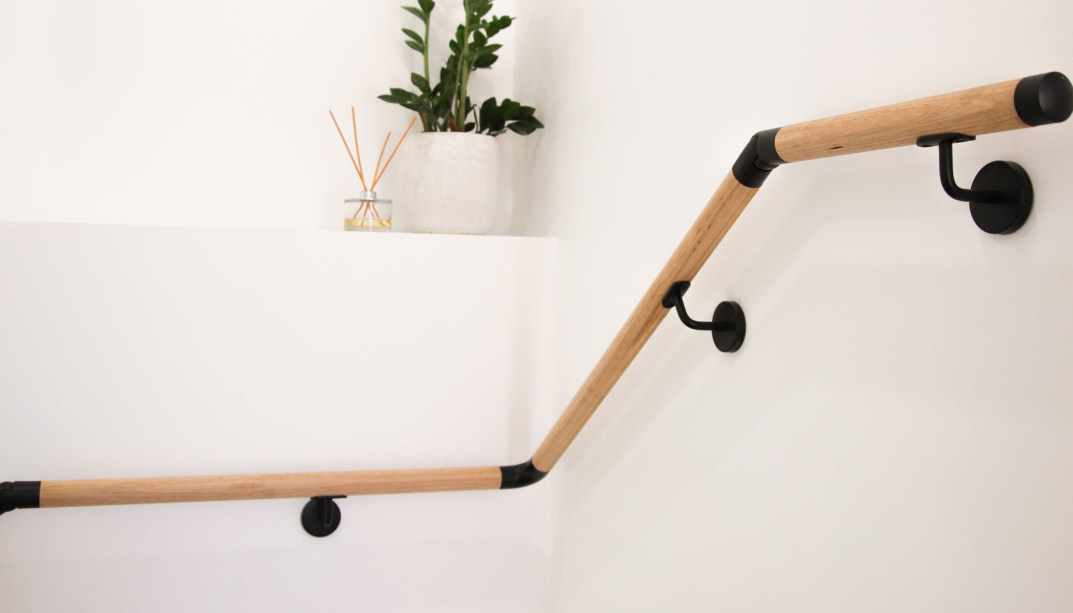 Porta wooden handrail mounted on the wall.