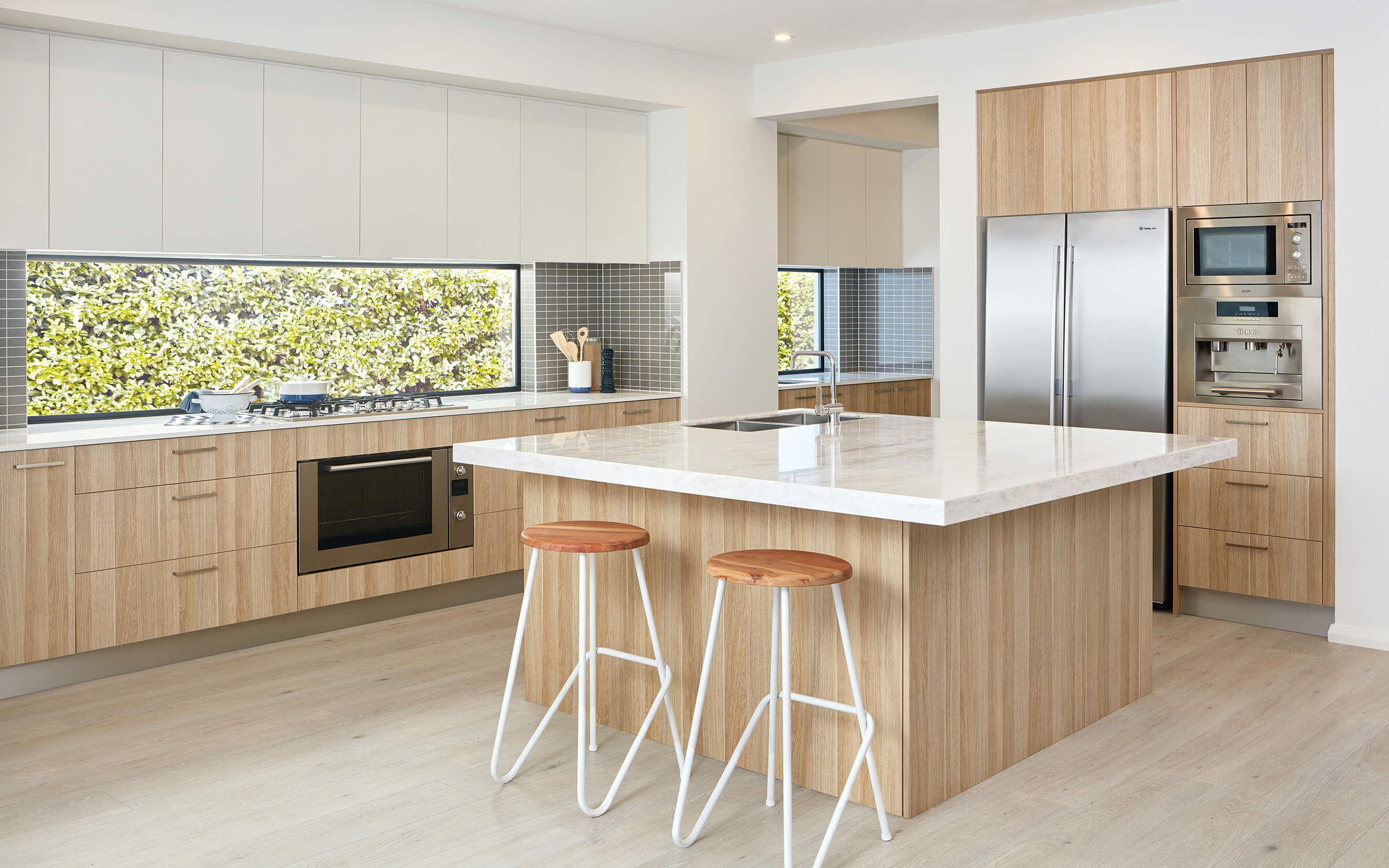 Wide shot of a colourpyne kitchen showing an island bench