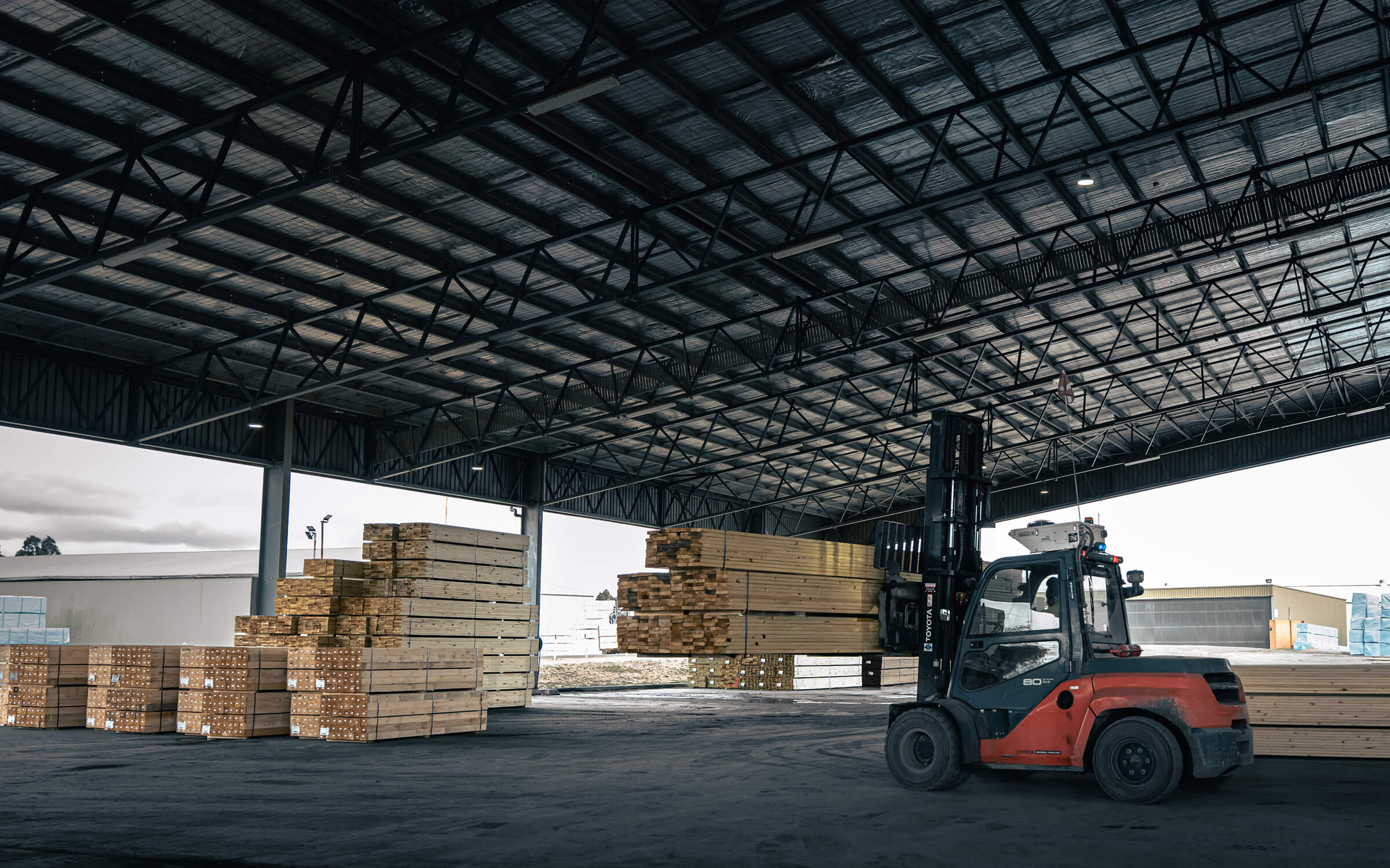 Forklift moving Stacked Timber