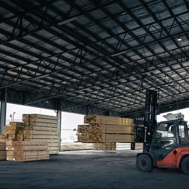 Forklift moving Stacked Timber