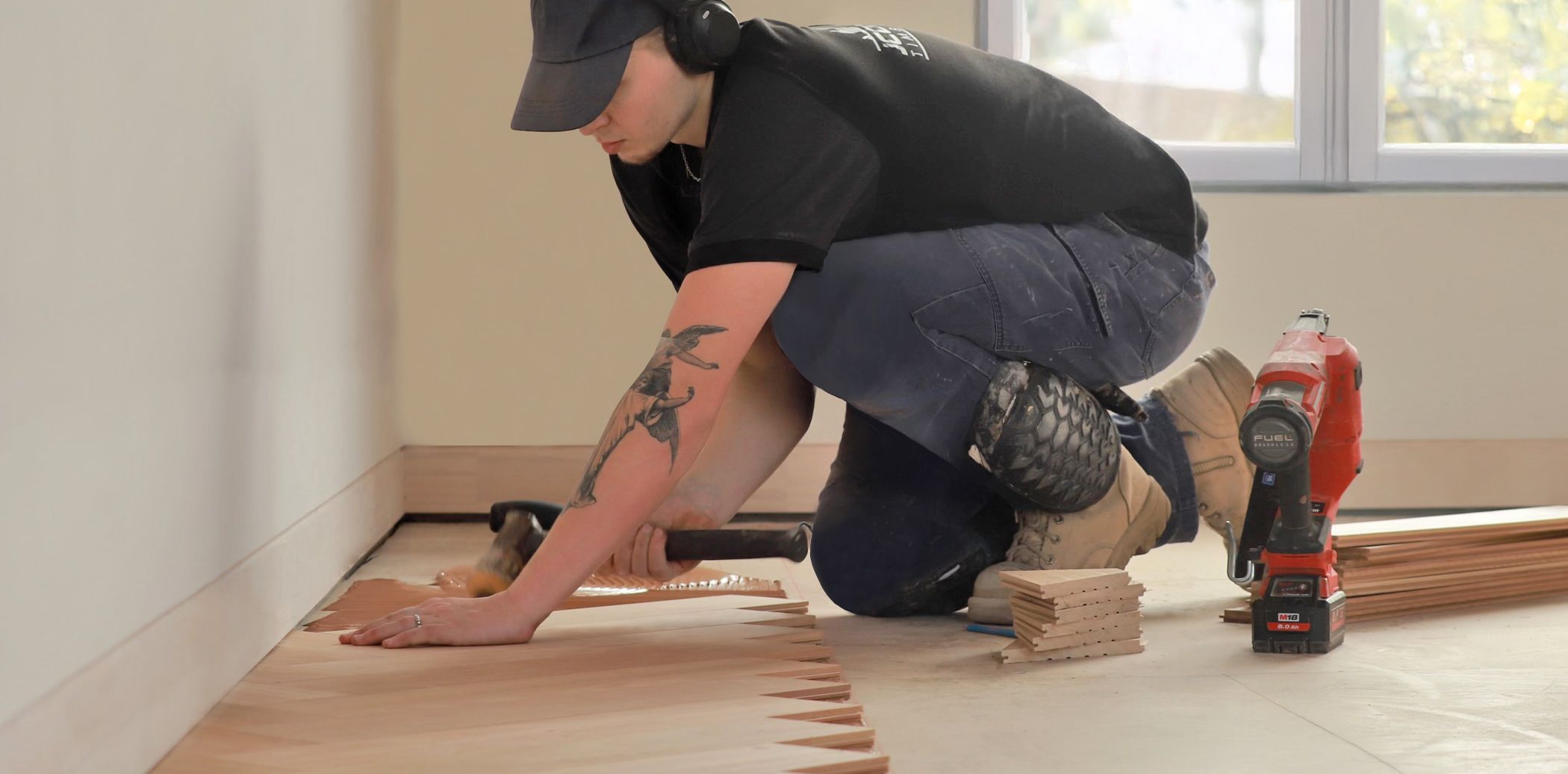 A photo of a carpenter installing parquetry floor over STRUCTApanel®