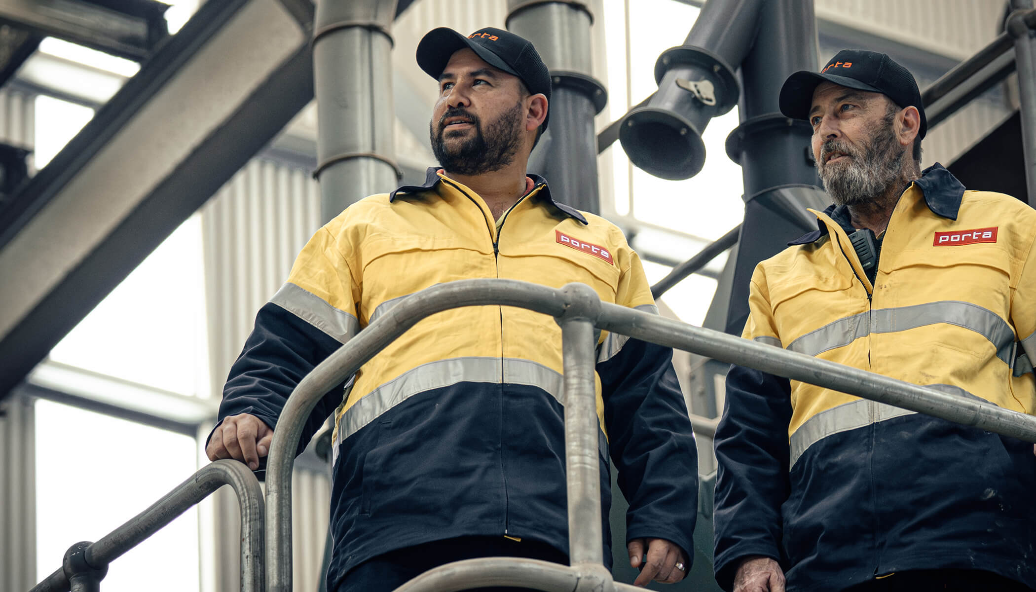Two men, at Porta's oberon facility, looking out to the distance