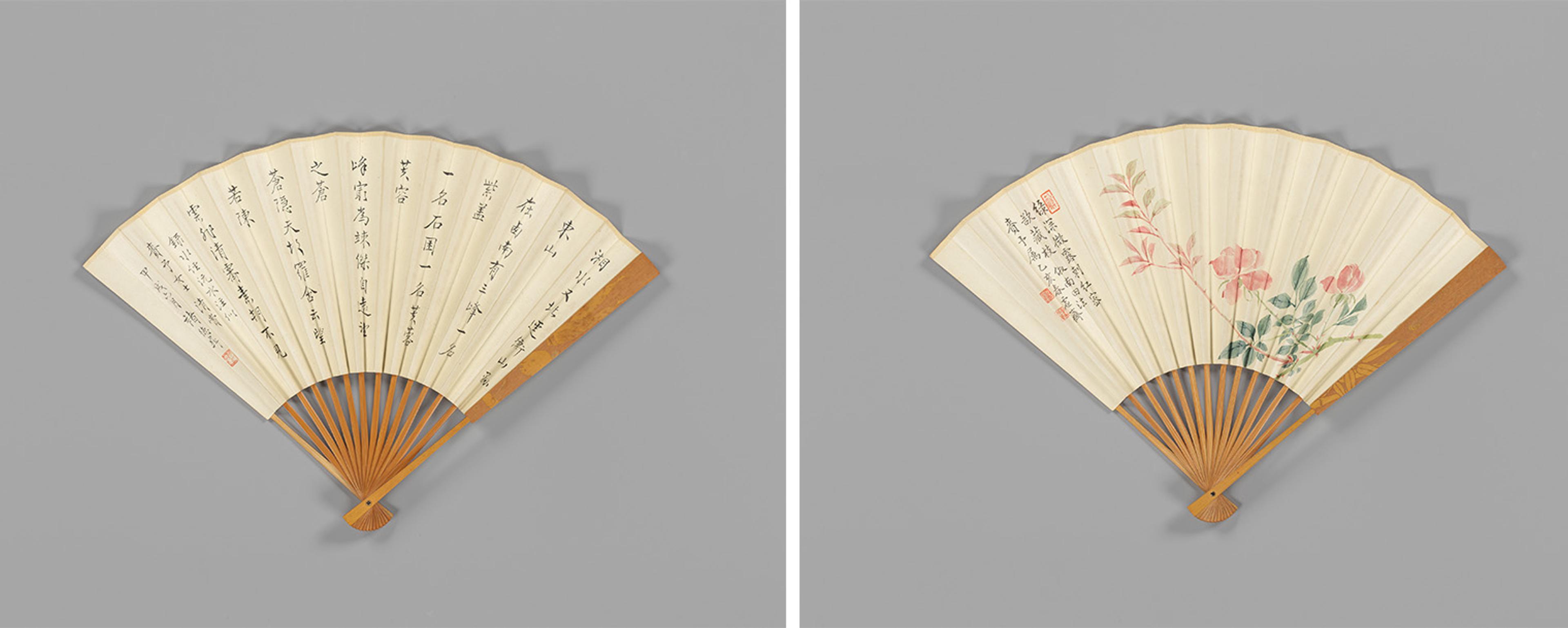 Two traditional folding fans with wooden frames. The left fan features elegant calligraphy, while the right fan depicts delicate pink flowers and greenery.