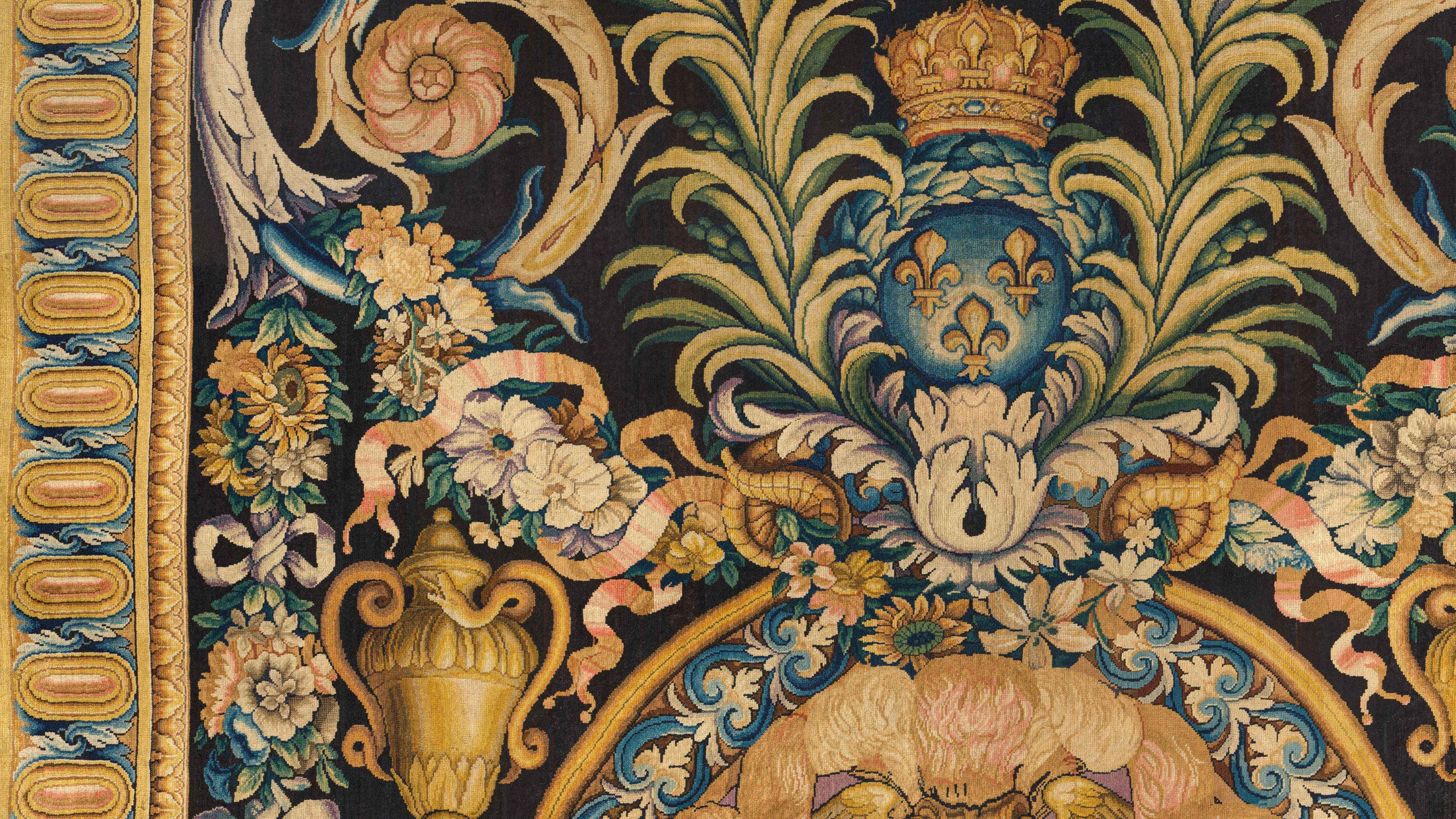 Intricate tapestry with floral motifs, a golden urn, and a crowned blue emblem with fleur-de-lis.