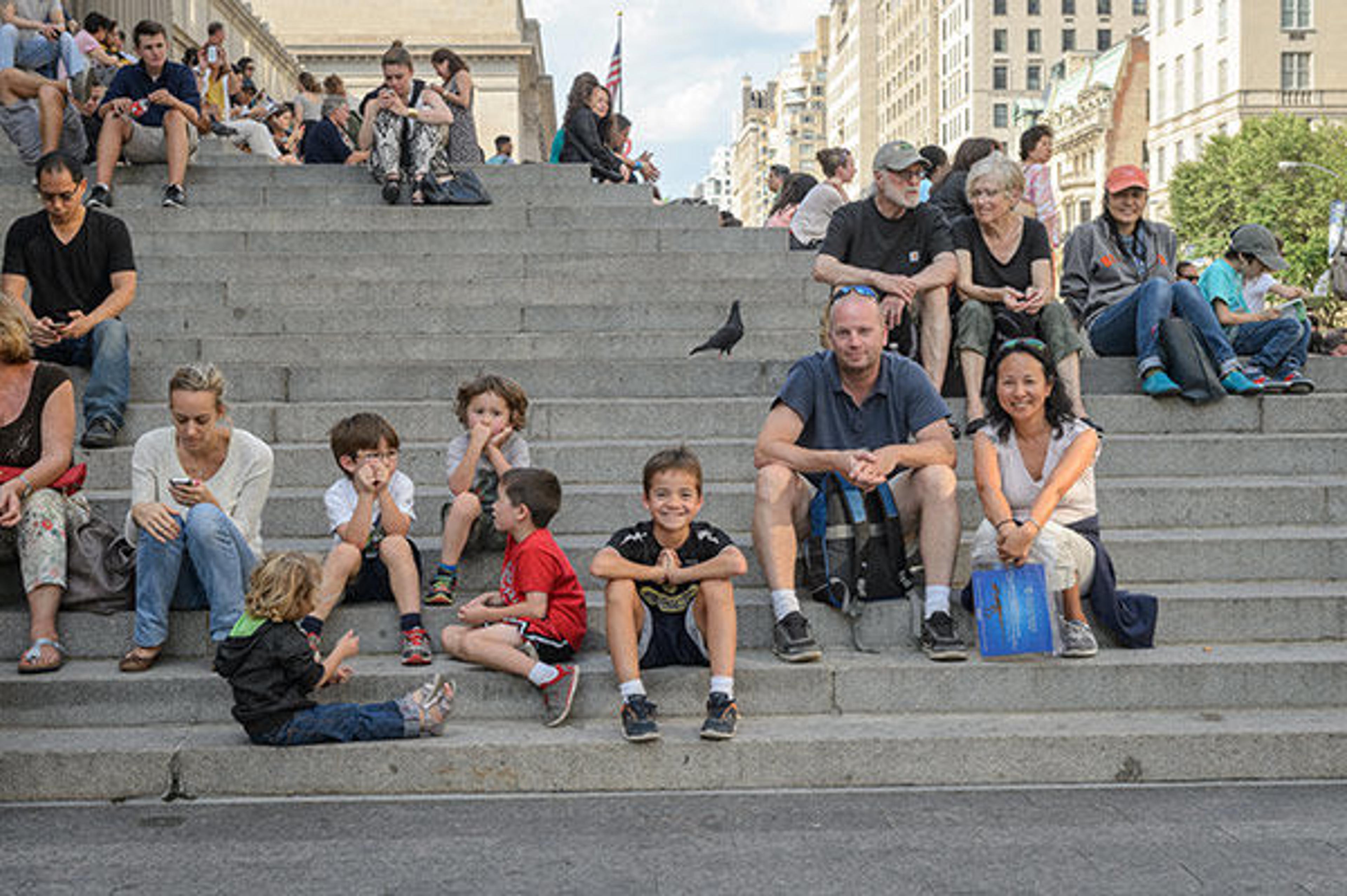 A family sat on the front steps of The Met Fifth Avenue