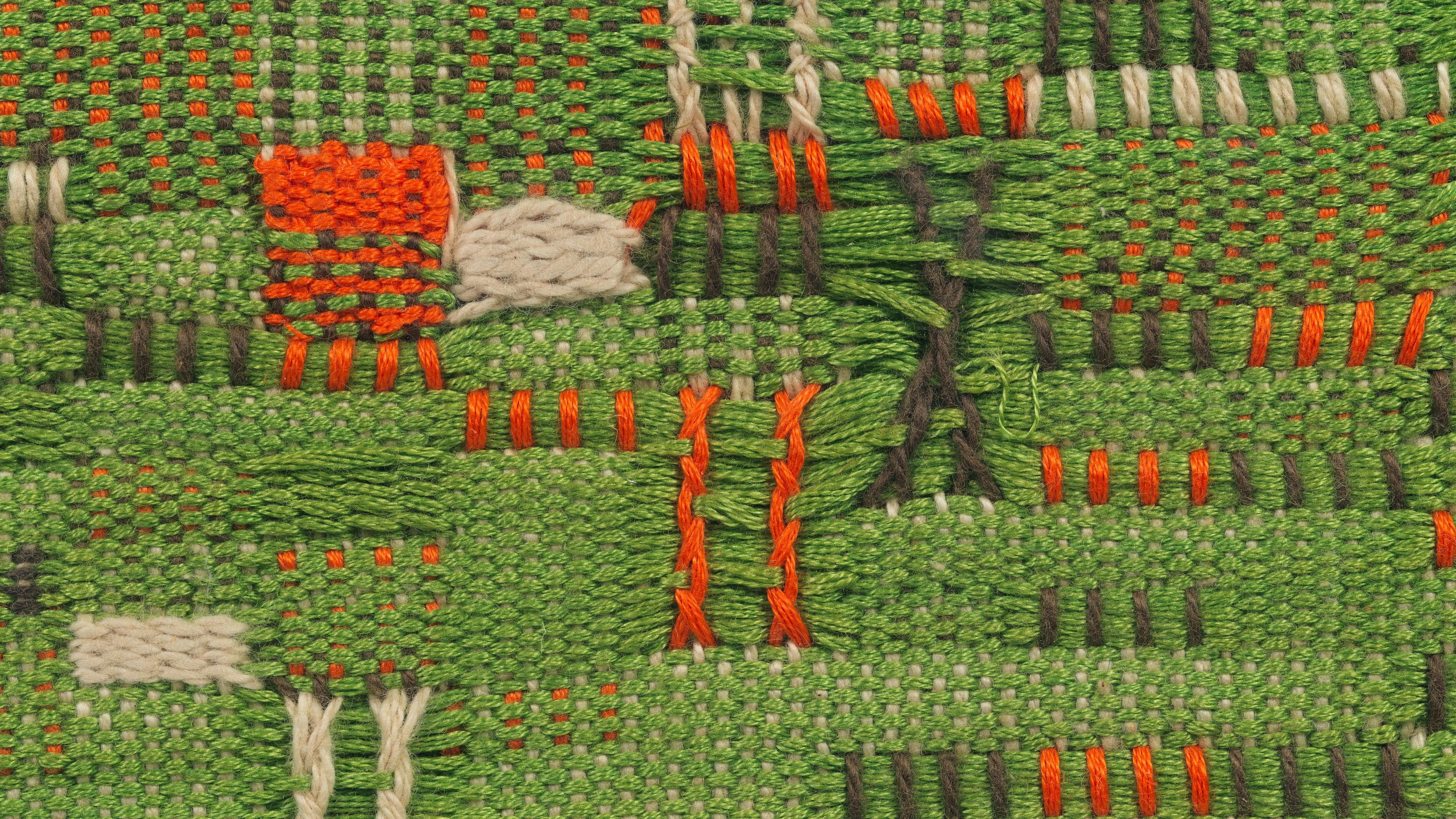 Weaving of mixed colors: green, orange, black, and white.